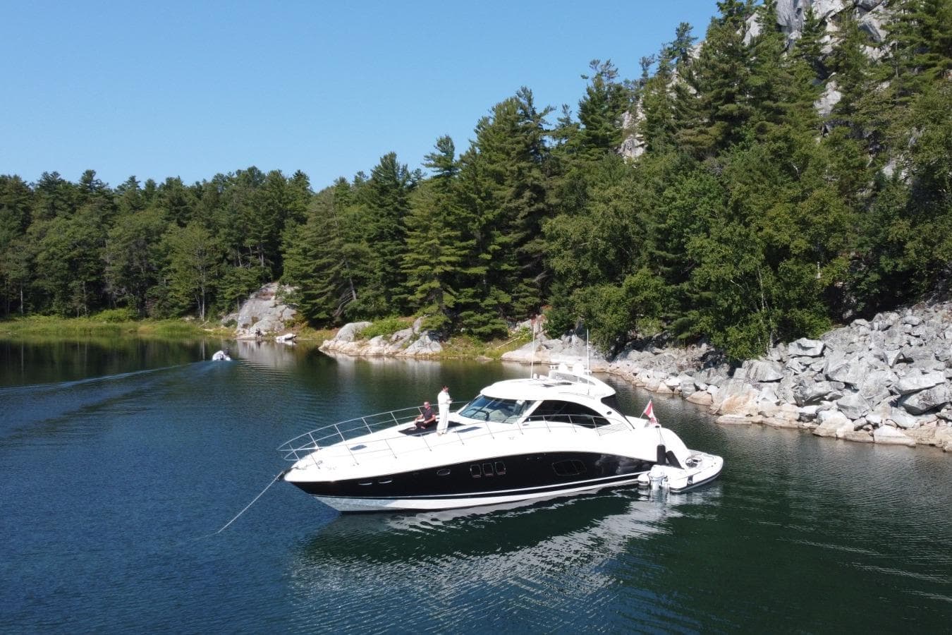 2008 Sea Ray 55 Sundancer yacht anchored in a scenic, forested cove.