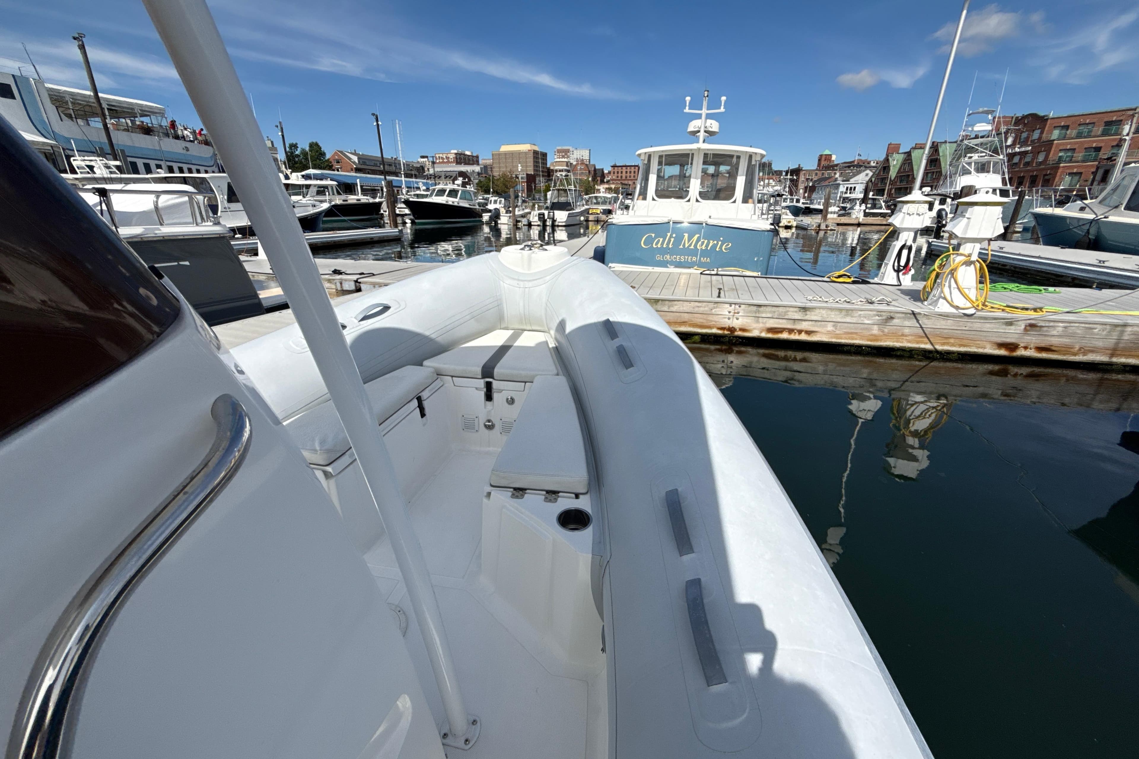 2020 AB Inflatables Oceanus 21 VST docked at a marina under clear blue skies.