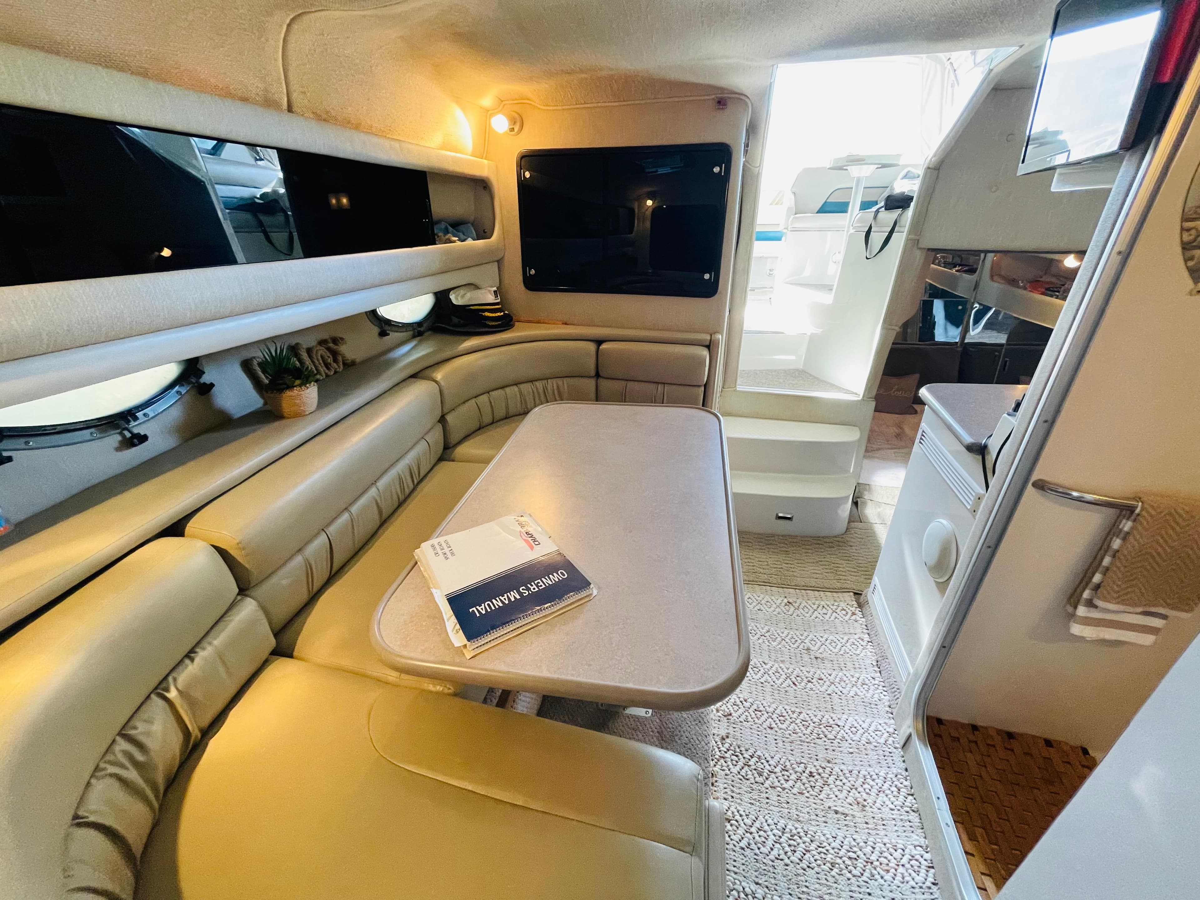 1996 Chaparral Signature 31 cabin interior with dining area and kitchenette.