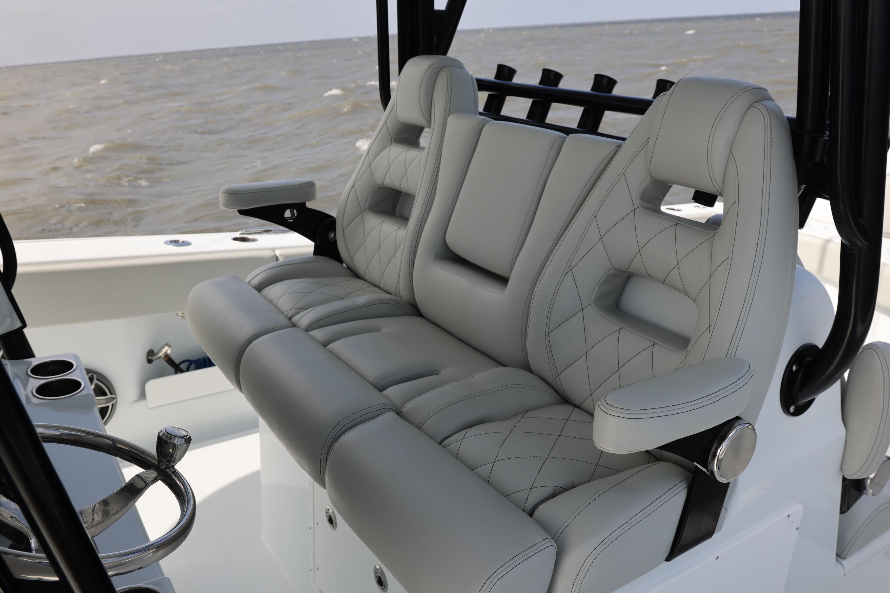 Luxurious seating on 2024 Freeman 38 boat with quilted upholstery and armrests.