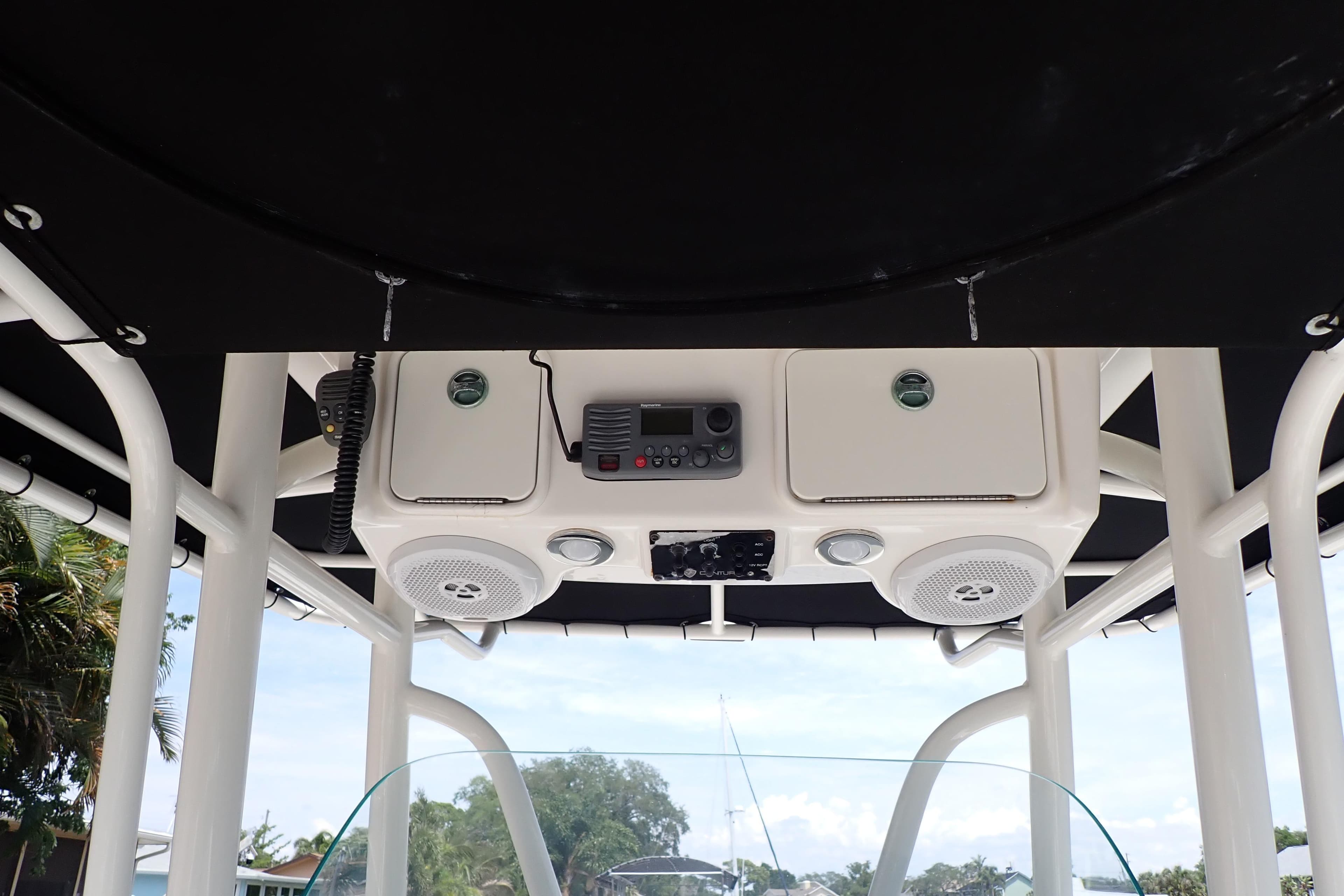2015 Century 2301 Center Console boat with overhead electronics and speakers.
