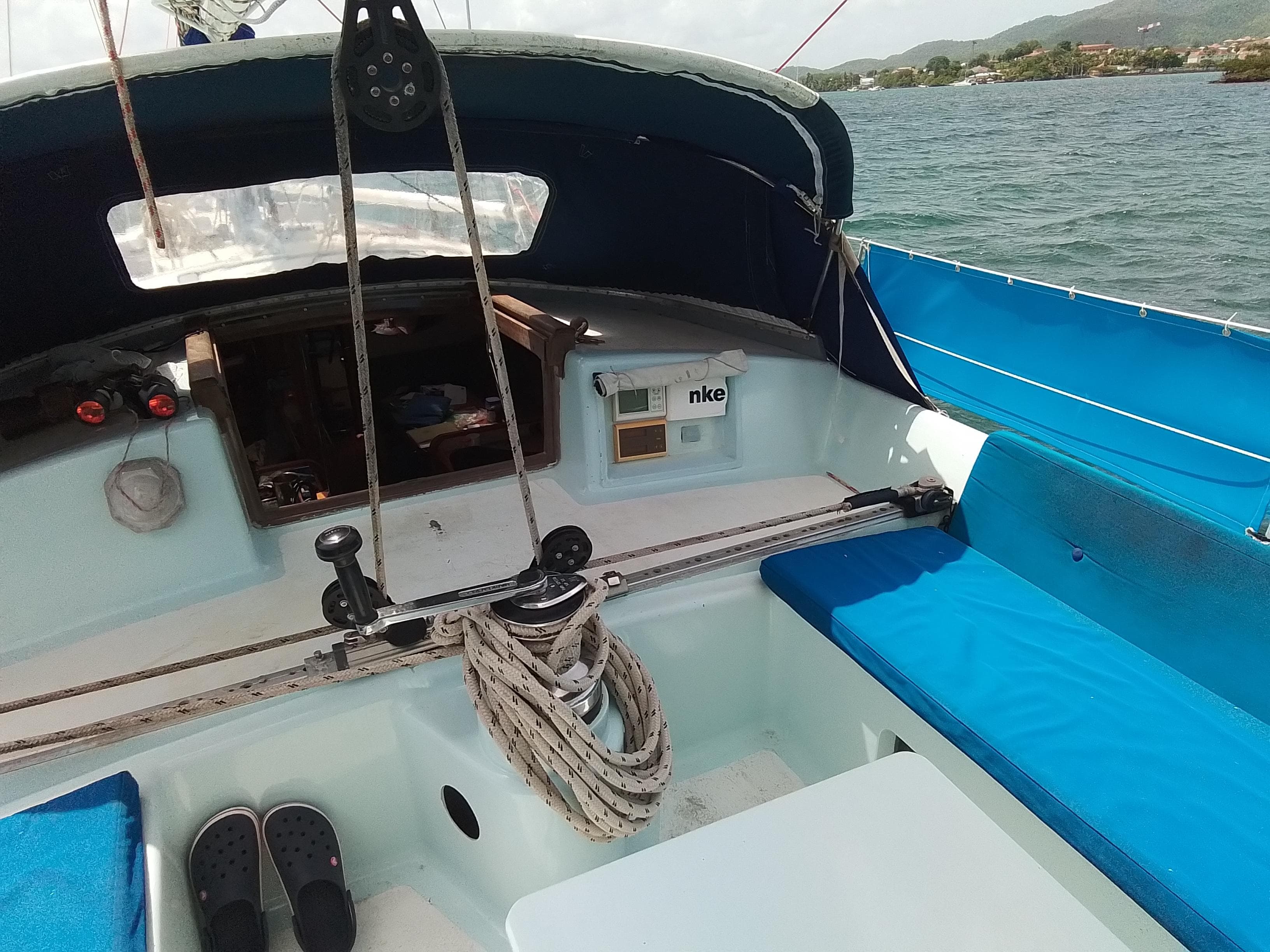 Cockpit of a 2000 Custom Paladin 60 sailboat with blue seating and nautical equipment.