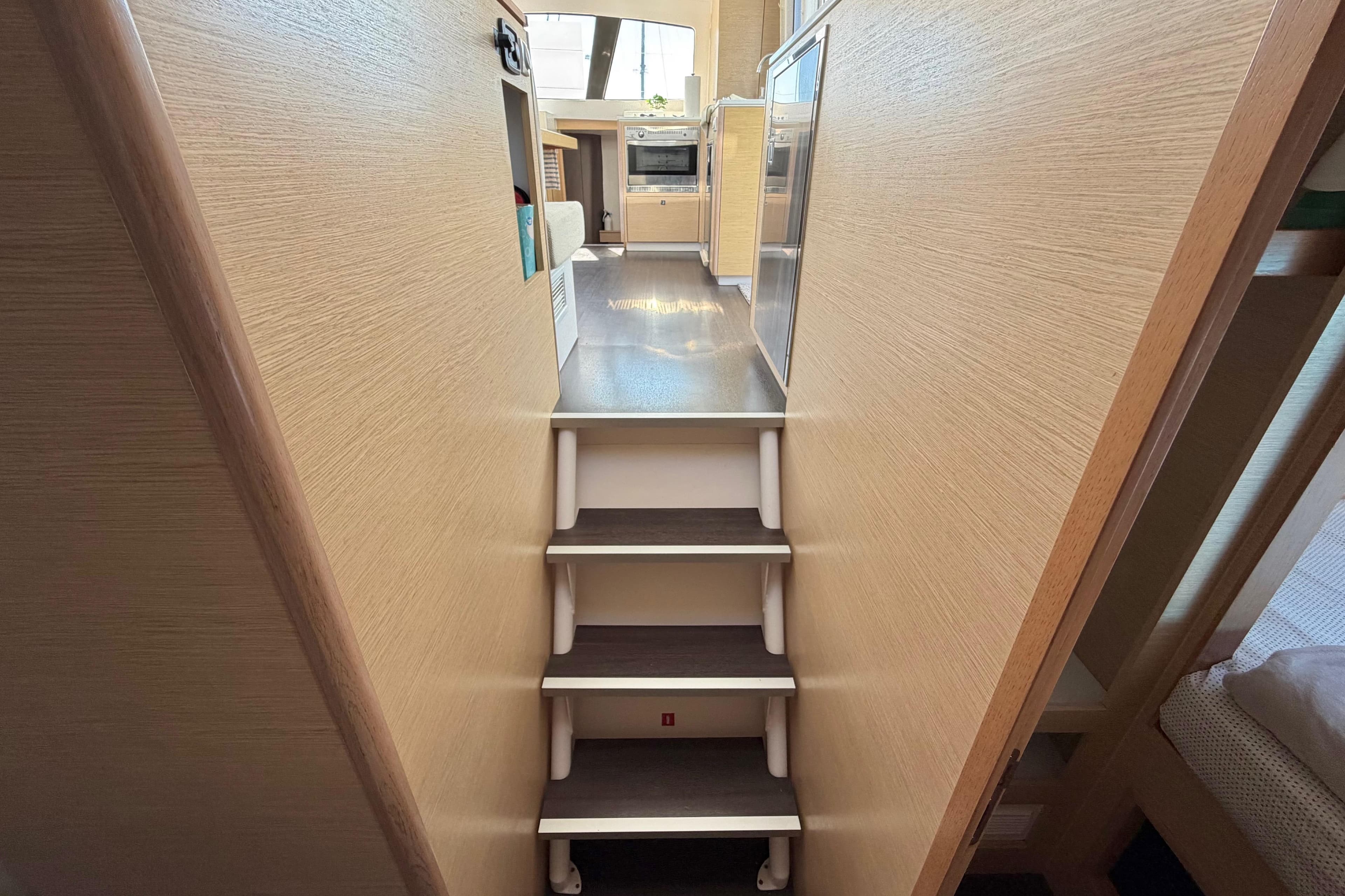 Interior view of 2014 Outremer 45 yacht, featuring stairs leading to the kitchen area.