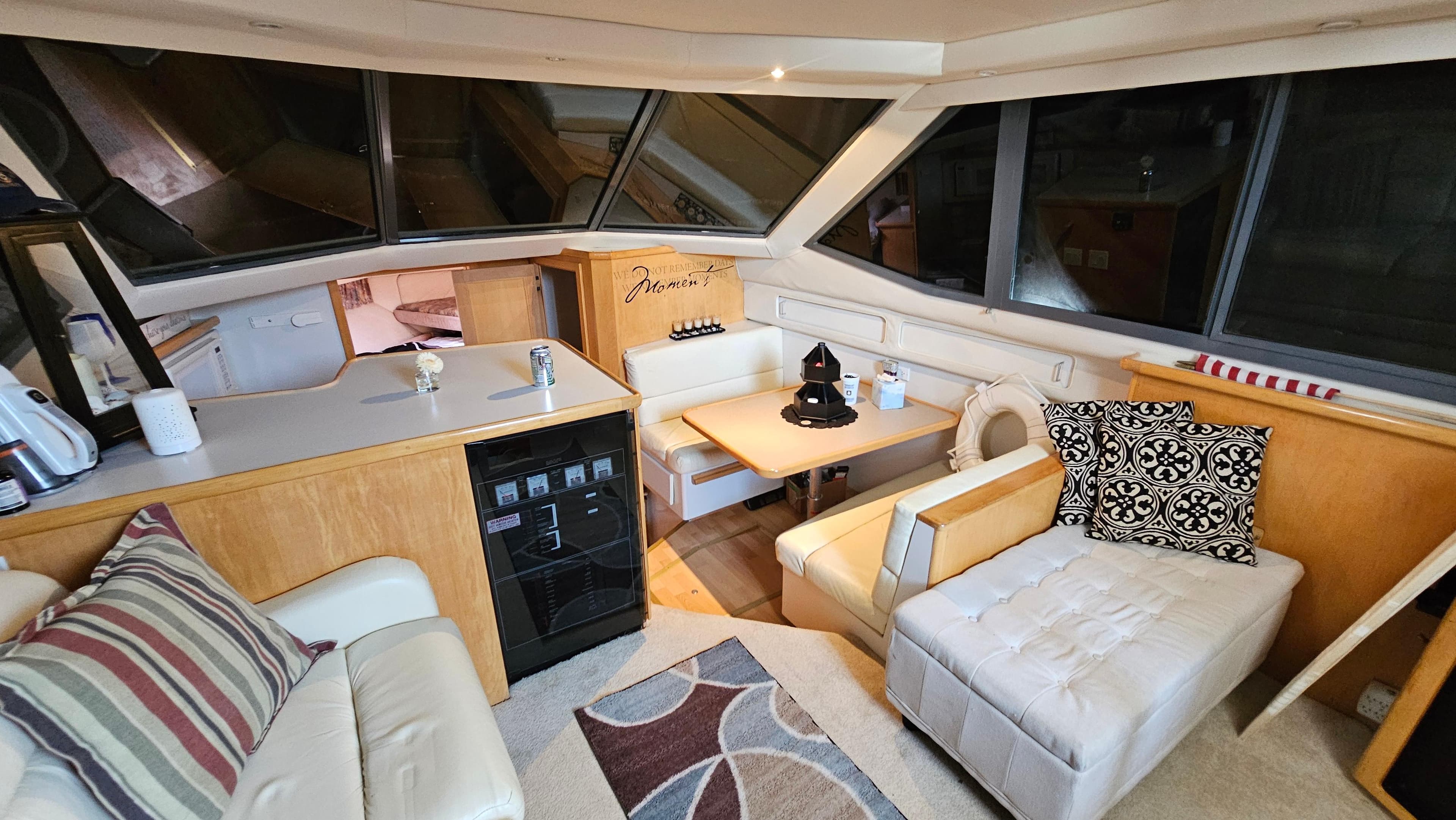 1995 Carver 355 Aft Cabin interior with cozy seating, dining area, and modern decor.