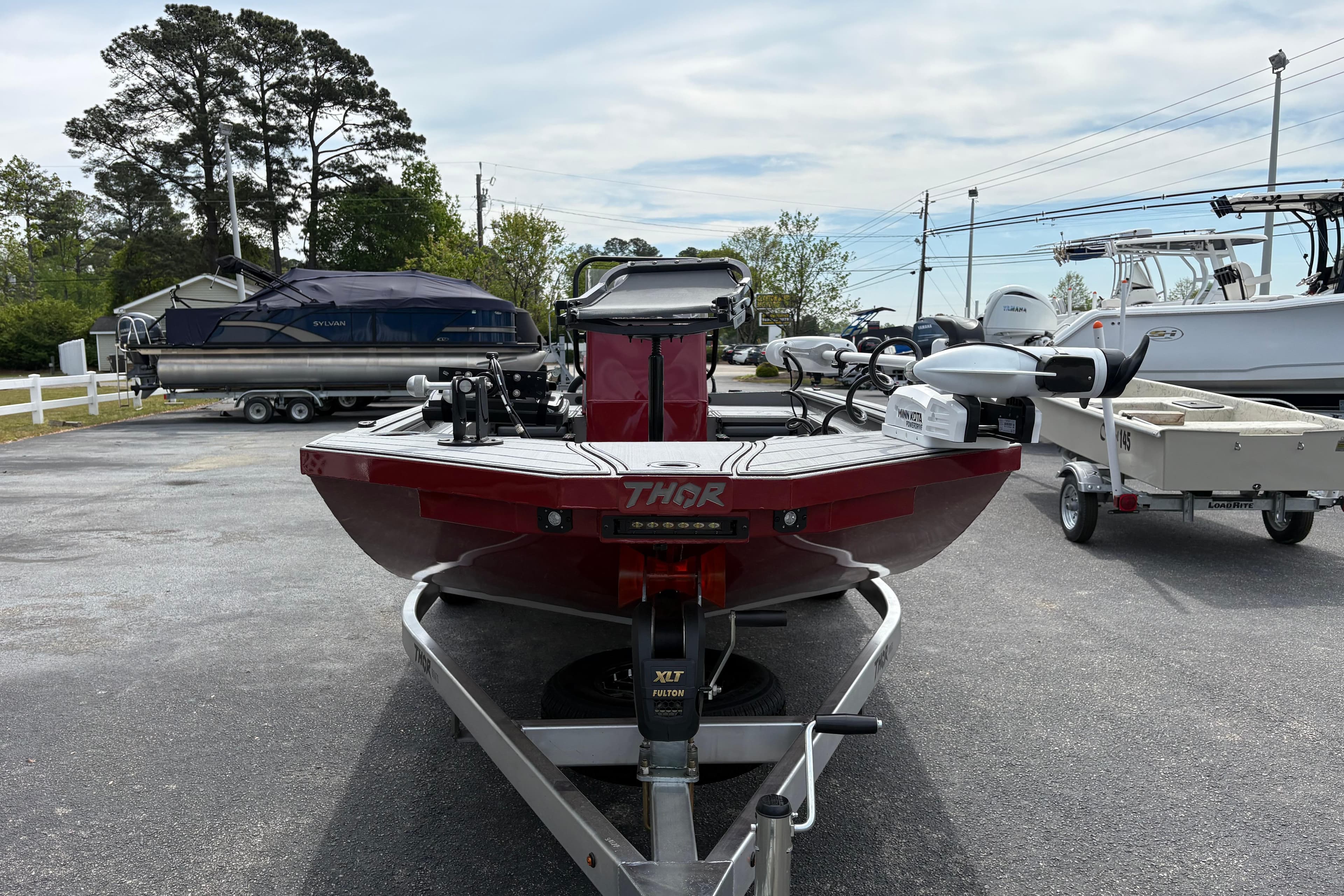 2025 Thor Lake Hammer 1900CC Elite boat on trailer in parking lot.