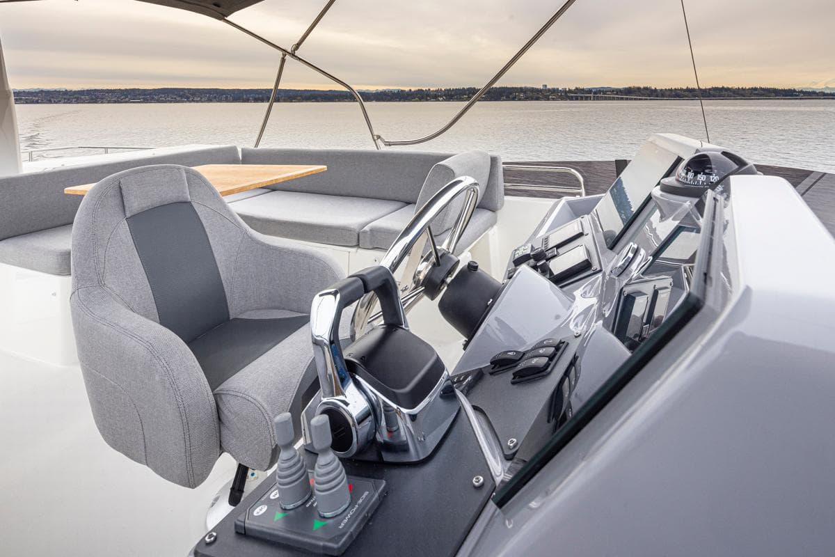 2026 Beneteau Swift Trawler 41 Flybridge helm with modern controls and seating.