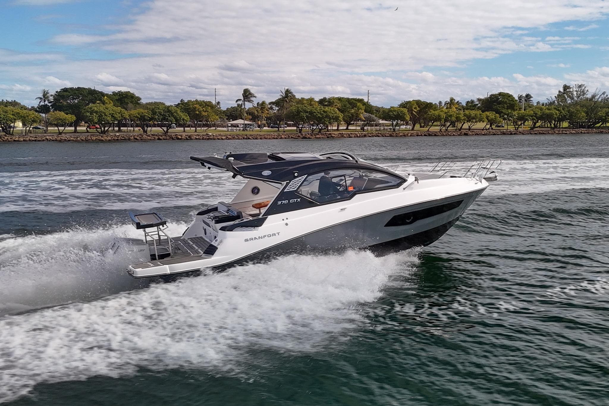 2026 Granfort 370 GTX luxury yacht cruising on a scenic waterway.
