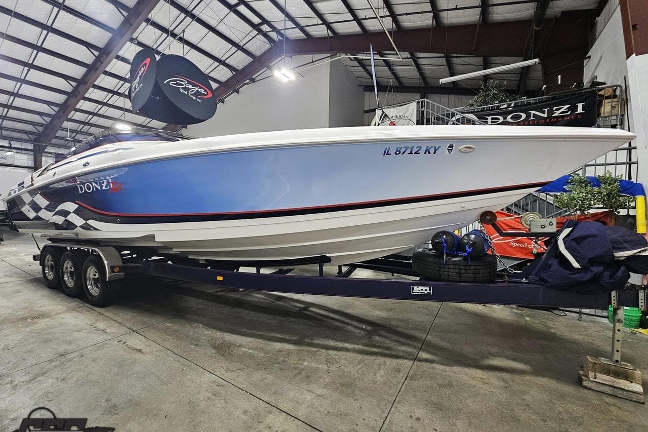 2000 Donzi 33 ZX speedboat on trailer in indoor storage facility.