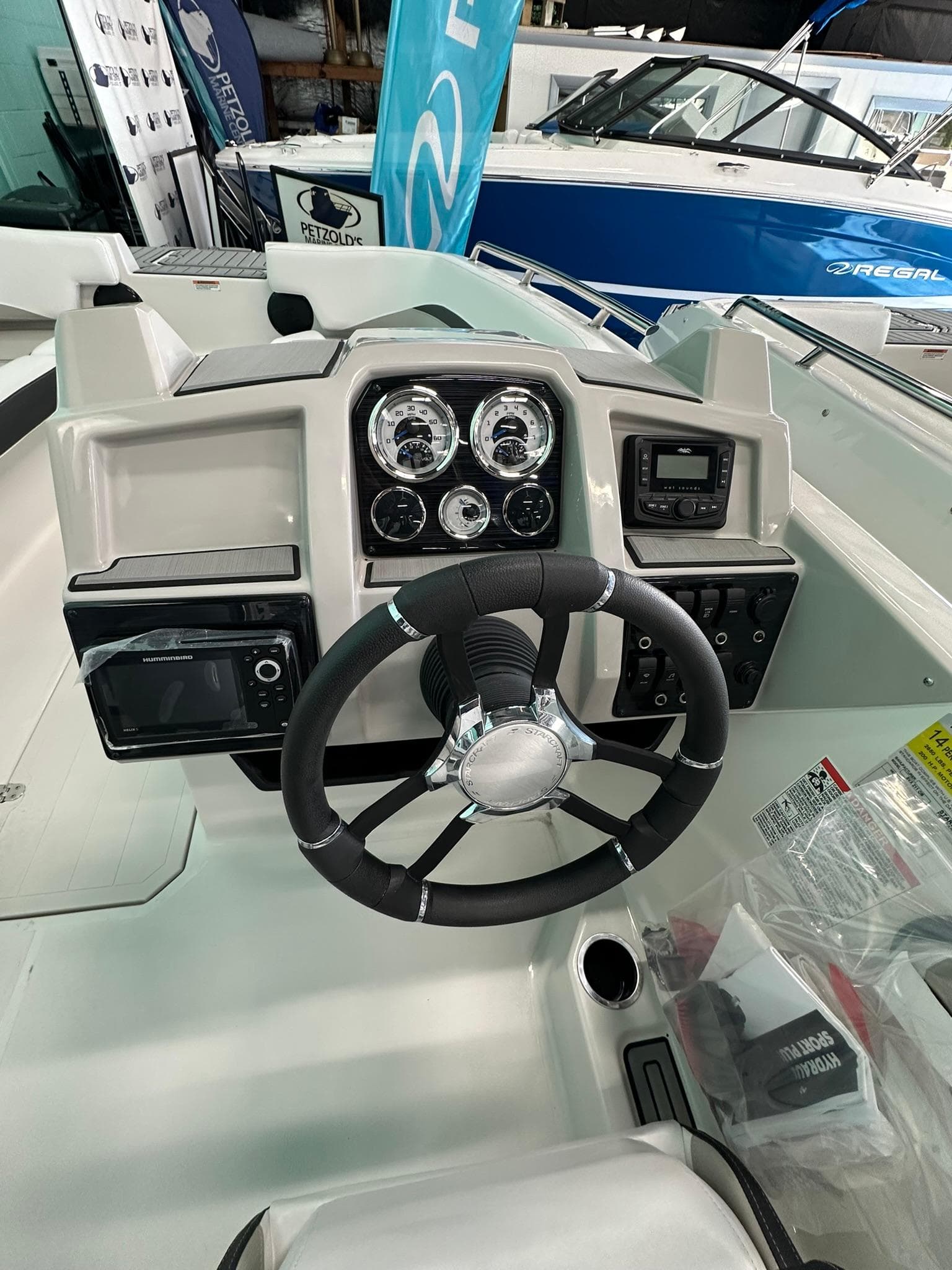 2025 Starcraft SVX 211 OB boat dashboard with steering wheel and gauges.