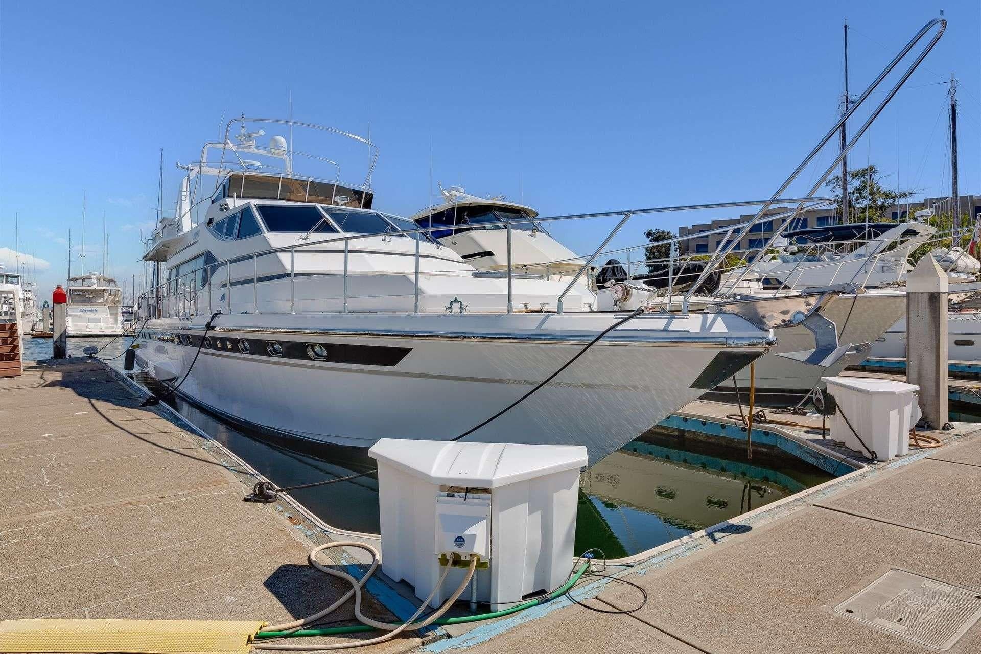 1988 Azimut Motor Yacht docked at marina under clear blue sky.
