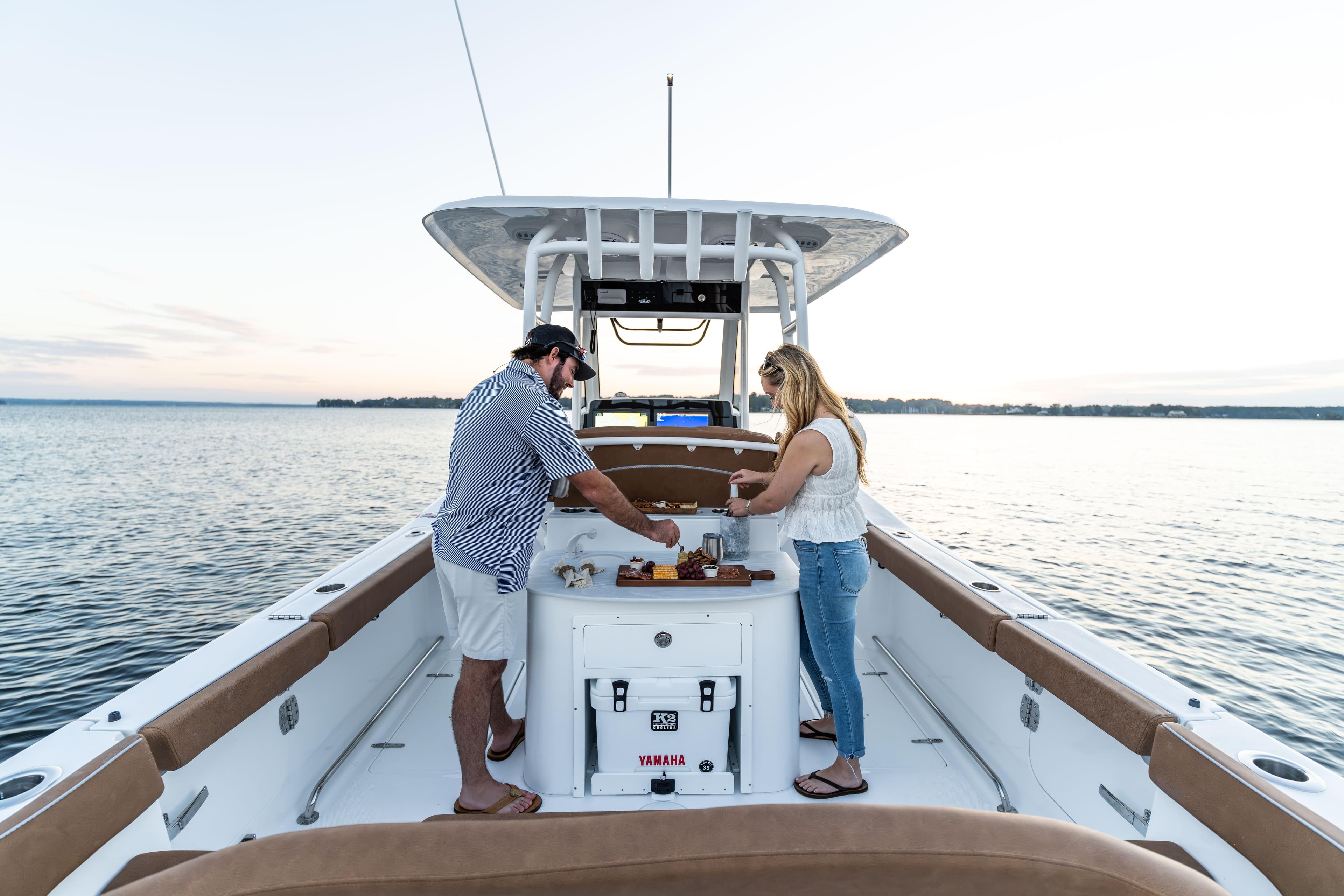 Couple enjoying leisure time on 2026 Sea Hunt Ultra 285 SE boat.