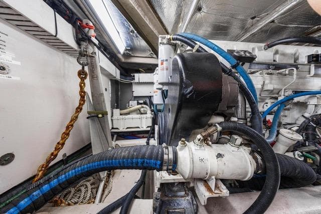 Engine room of 2007 Sea Ray 52 Sedan Bridge with visible machinery and cables.