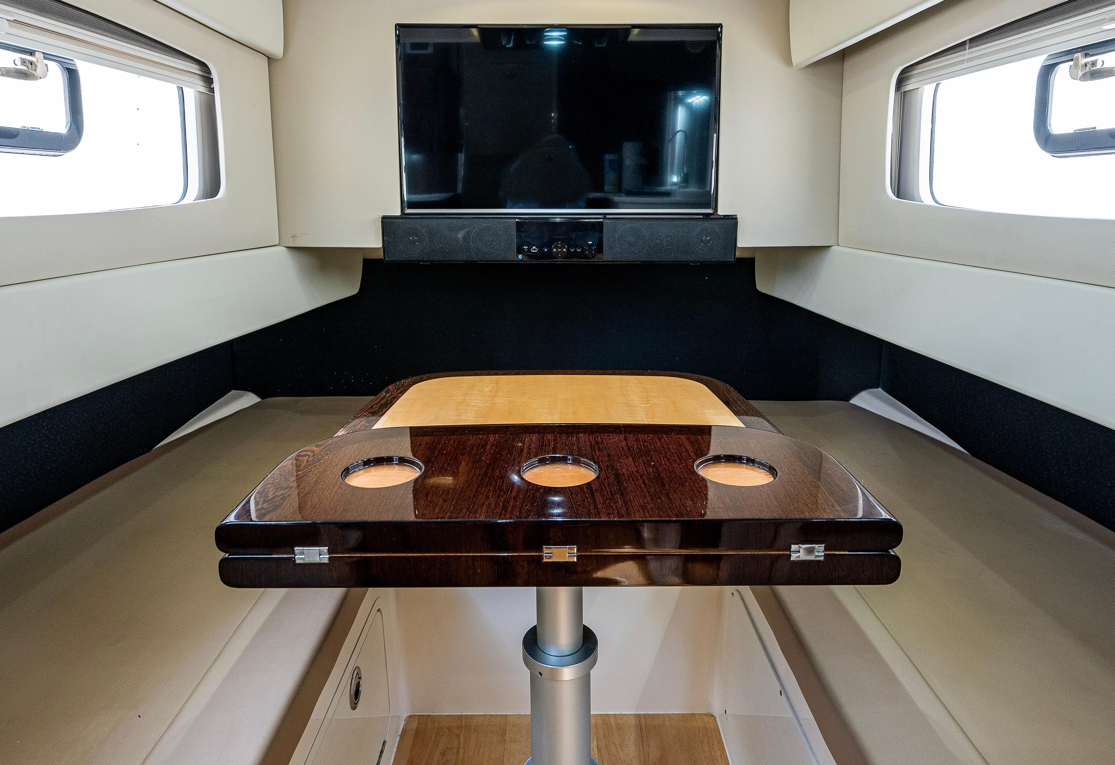 2019 Scout 420 LXF cabin interior with table and TV, featuring modern design and comfort.