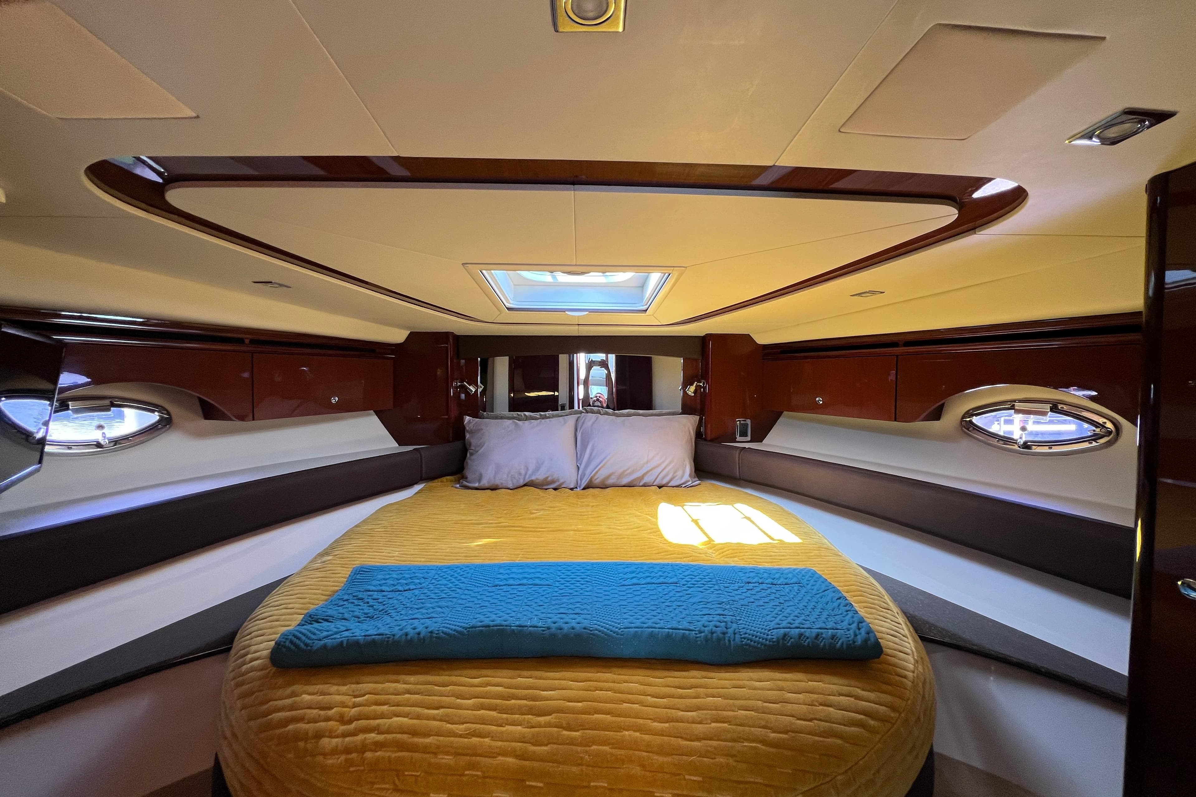 Luxurious interior of 2013 Meridian 441 Sedan yacht with cozy bed and elegant design.