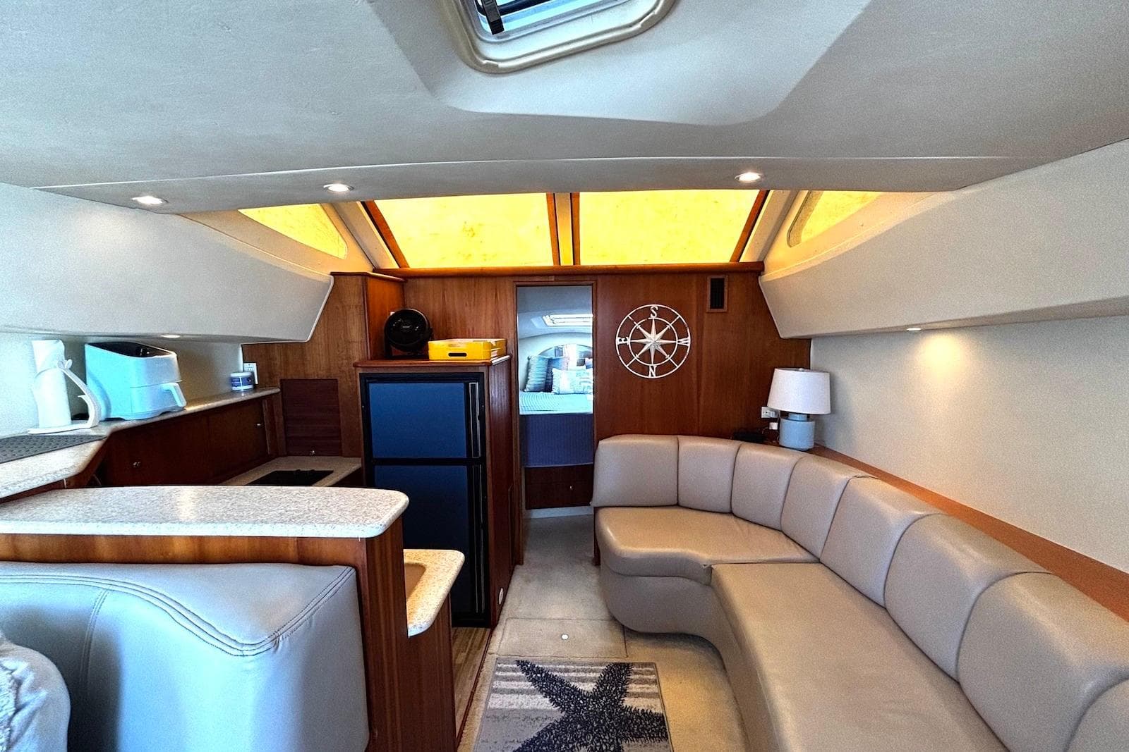 Interior of 2001 Silverton 330 Sport Bridge yacht with modern seating and kitchenette.