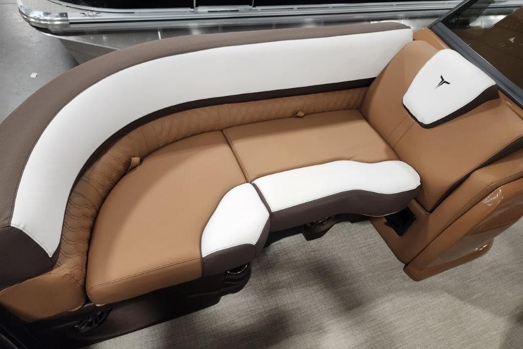 Luxurious seating in the 2026 Avalon 23 LSZ VRB Windshield boat, featuring brown and white upholstery.