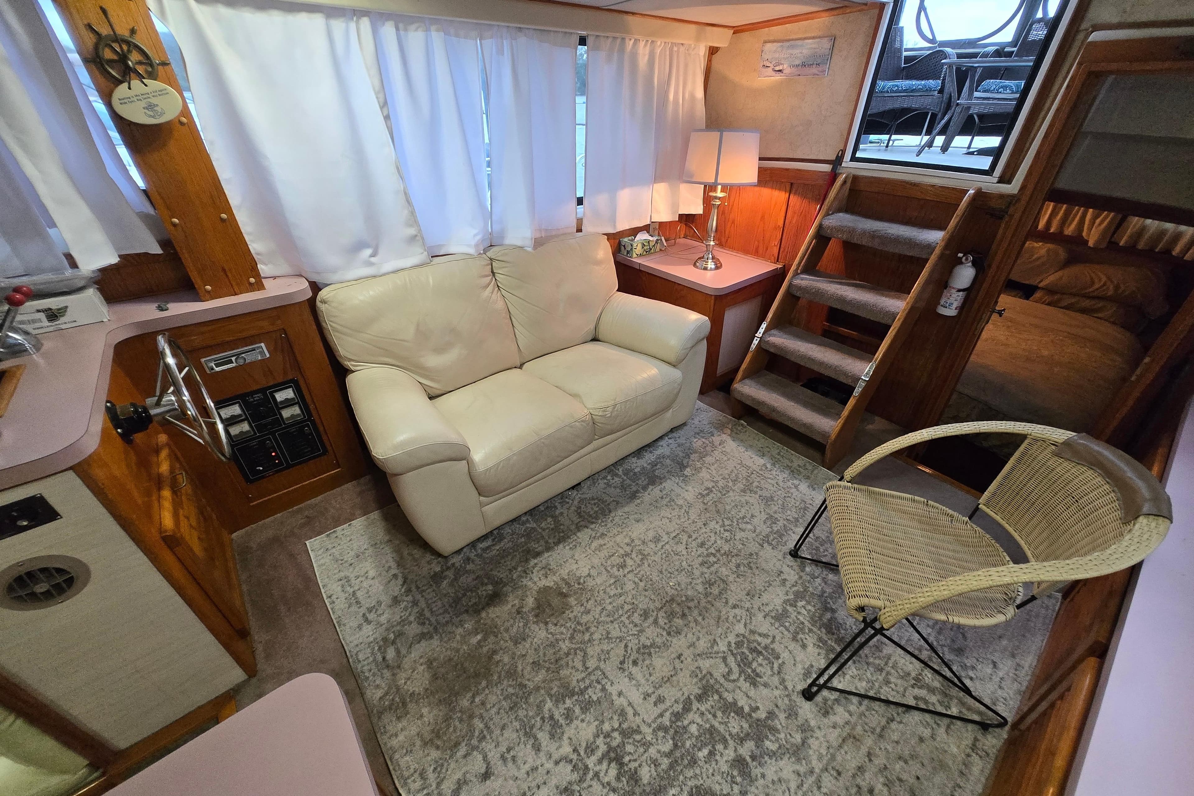 Interior of 1988 Mainship 36 Double Cabin with cozy seating and nautical decor.