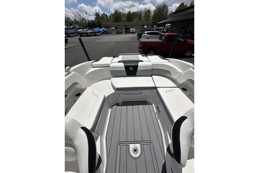 2023 Chaparral 23 Surf boat interior with white seating and gray flooring.