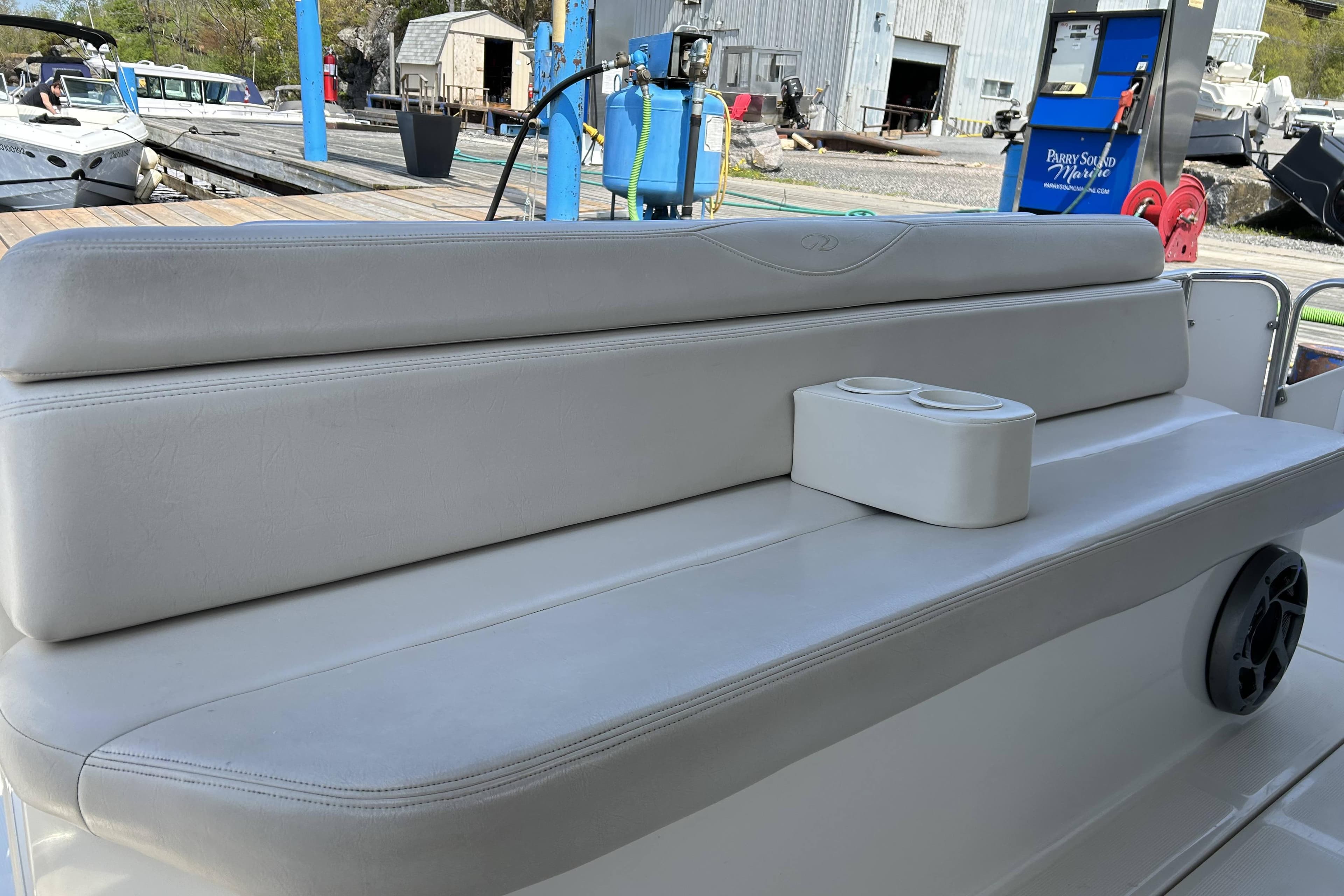 White leather seating on a 2002 Regal Commodore 4260 boat, dockside view.
