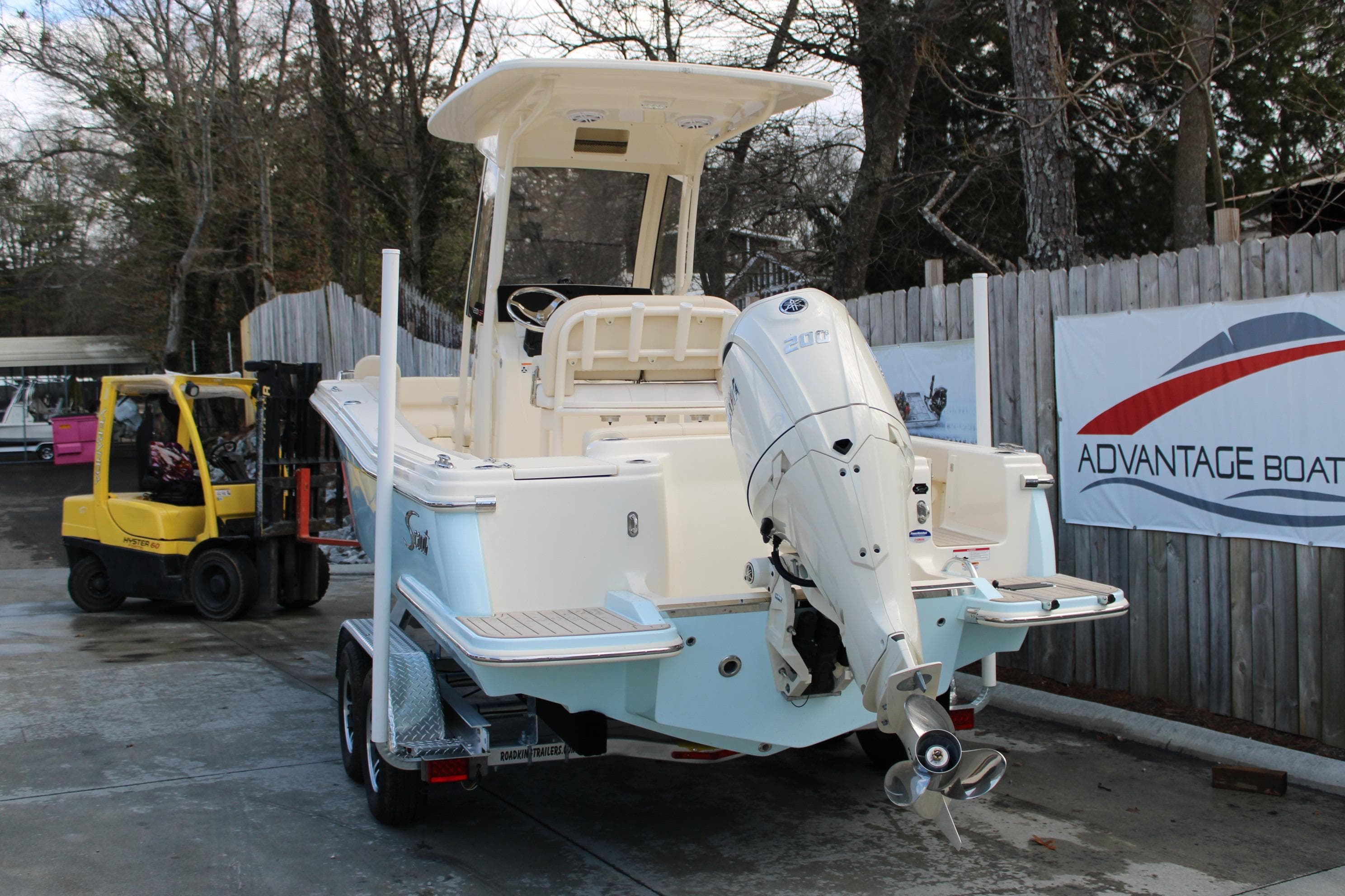 2026 Scout 220 XSF boat on trailer, parked near Advantage Boat sign.
