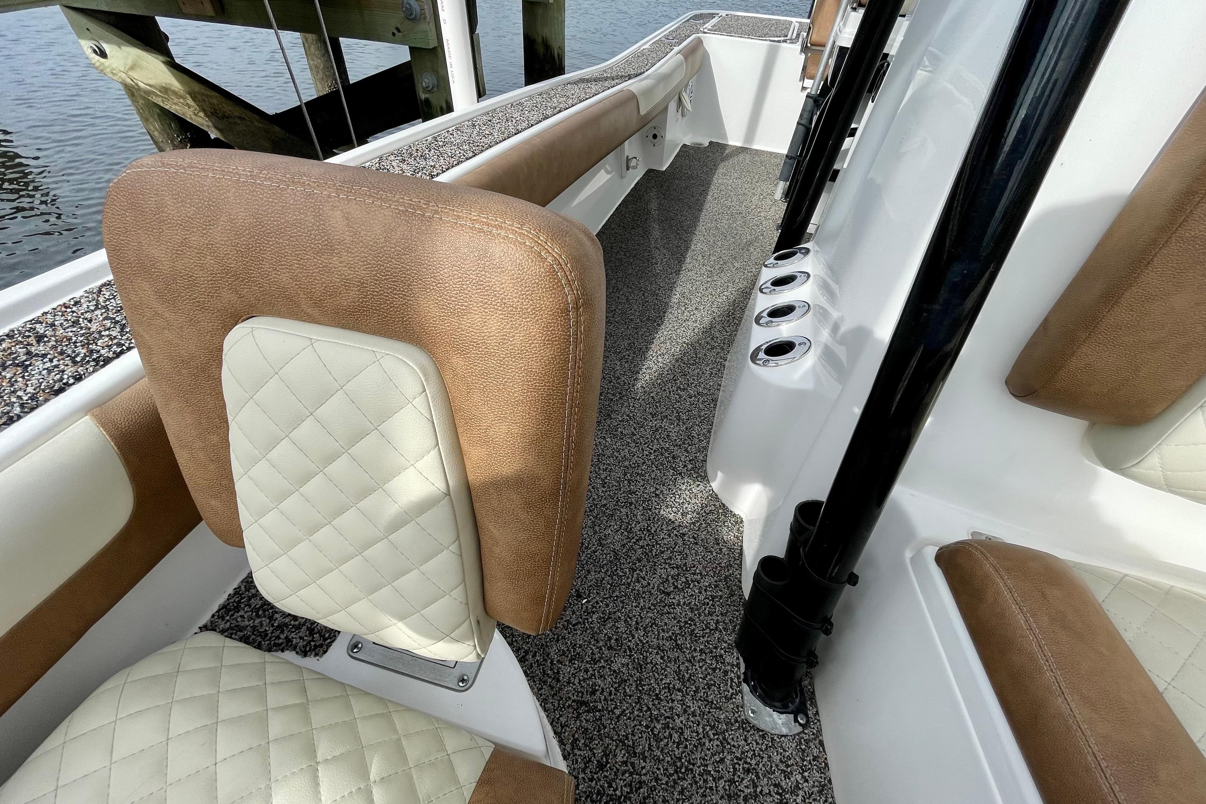 2021 Caymas 26 HB boat interior with cushioned seating and rod holders.