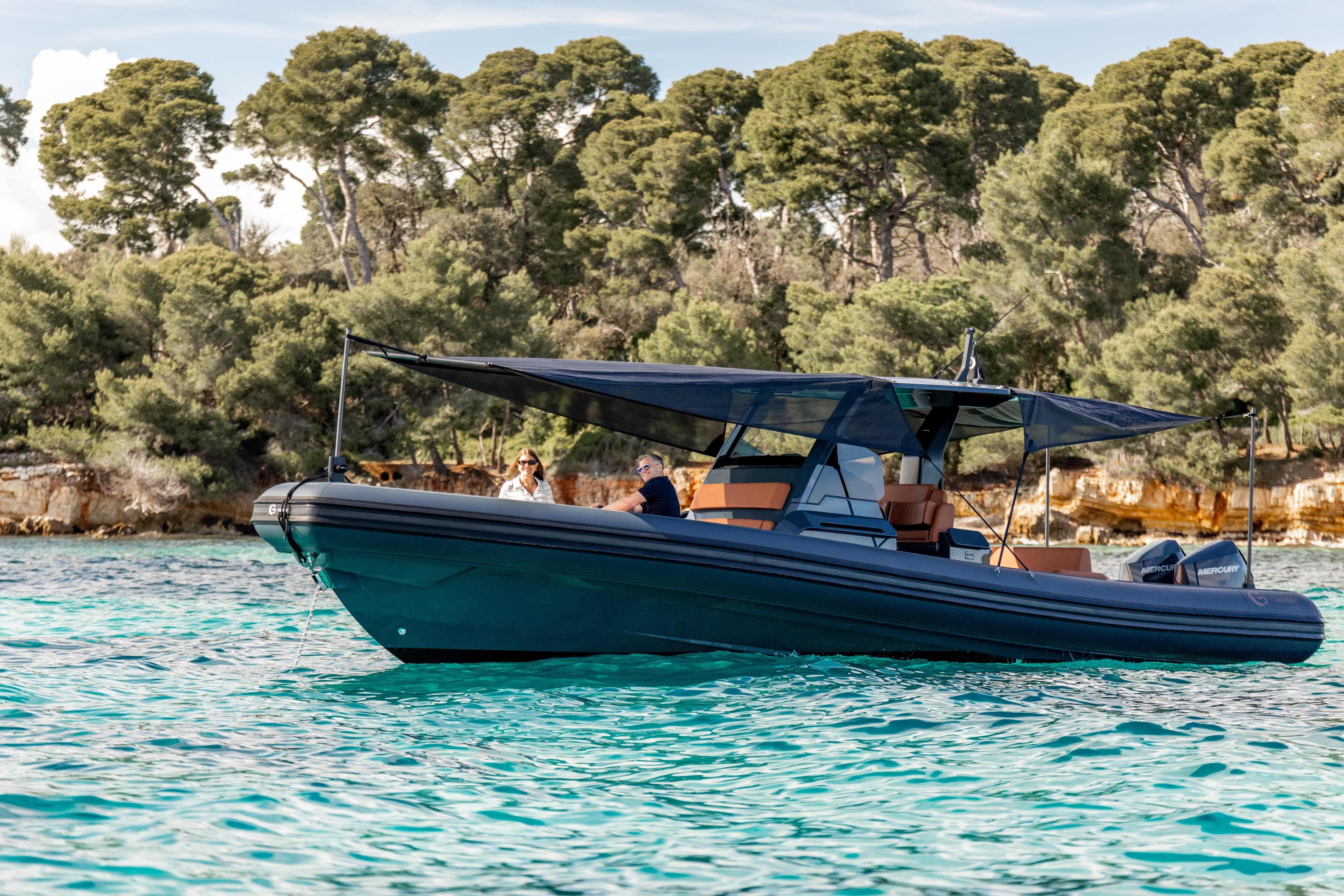 2026 G-Tender DIECI boat cruising on turquoise waters near a forested shoreline.