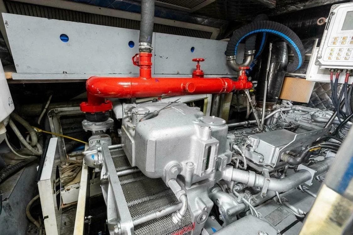 Engine room of 2006 Tecnomar 35 Nadara yacht, featuring complex machinery and red piping.