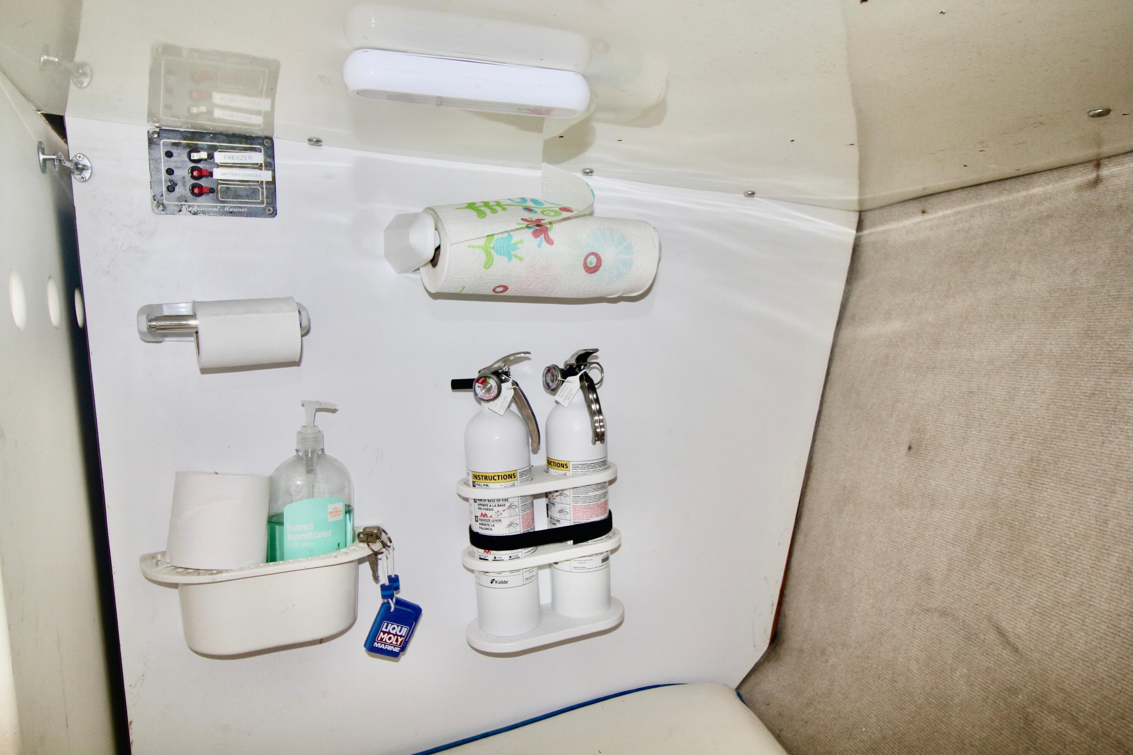 Interior of a 1970 Bertram 31 Sportfisher with safety equipment and hygiene supplies.