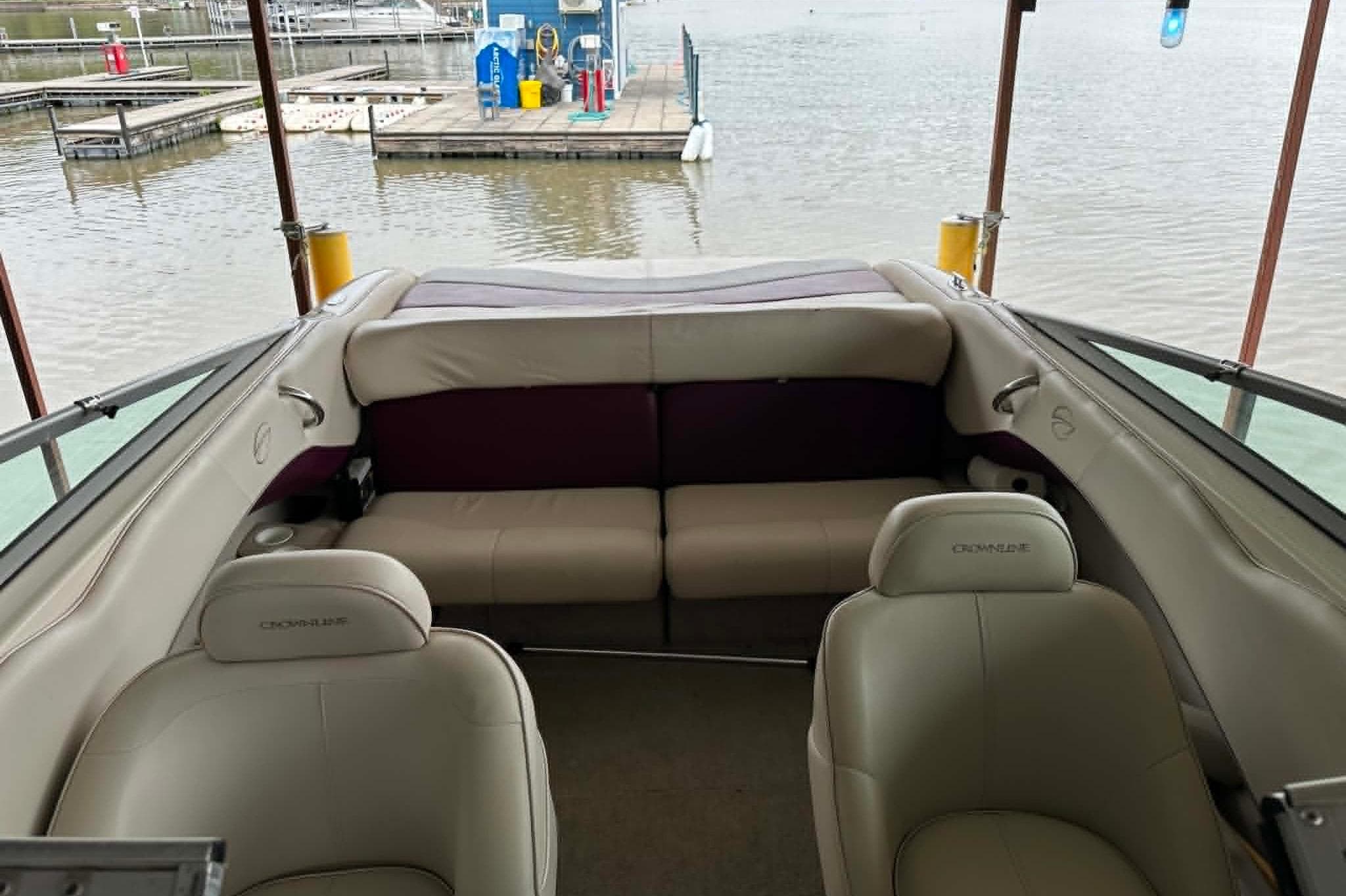 Interior of a 1998 Crownline 248 BR boat with beige seating at a dock.