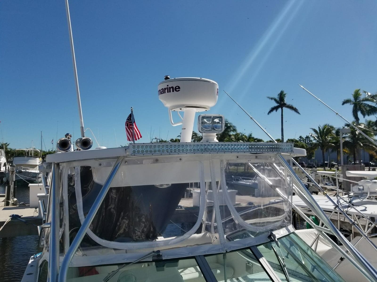 2006 Stamas 320 Express boat docked, featuring radar and American flag.