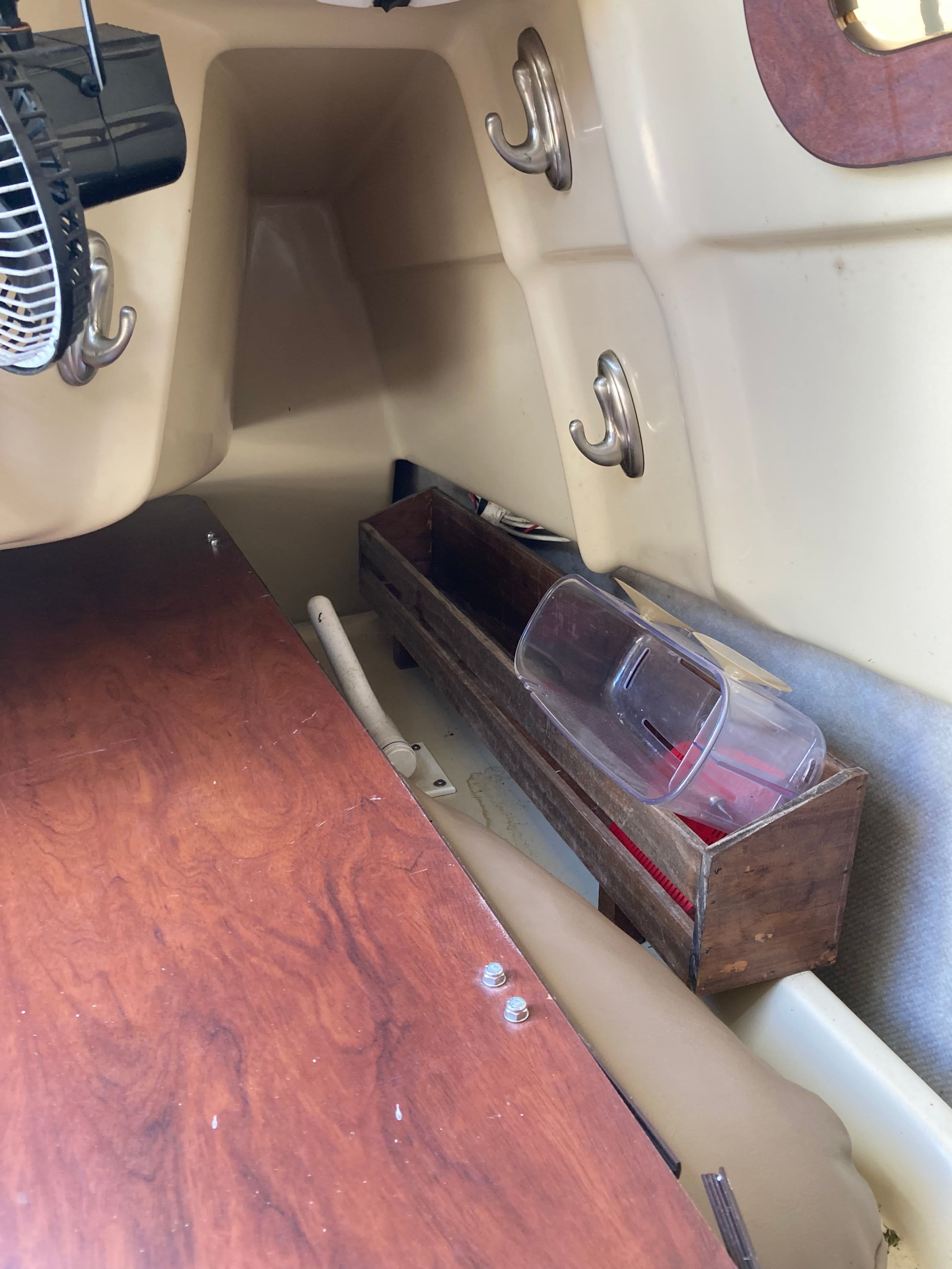 Interior of a 2007 MacGregor 26 with wood details and storage.