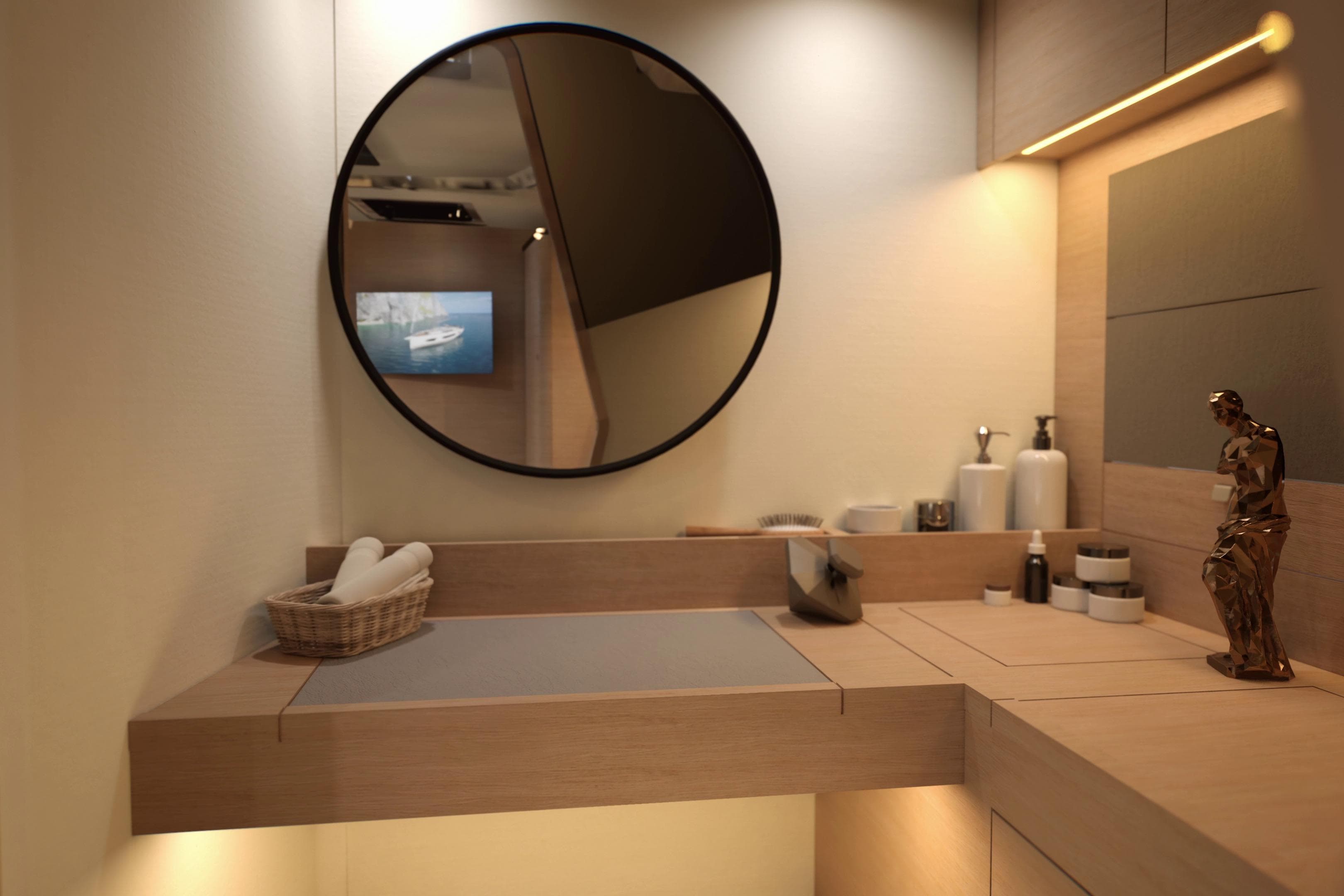 Modern bathroom interior on 2026 Dufour 54 yacht, featuring round mirror and elegant decor.