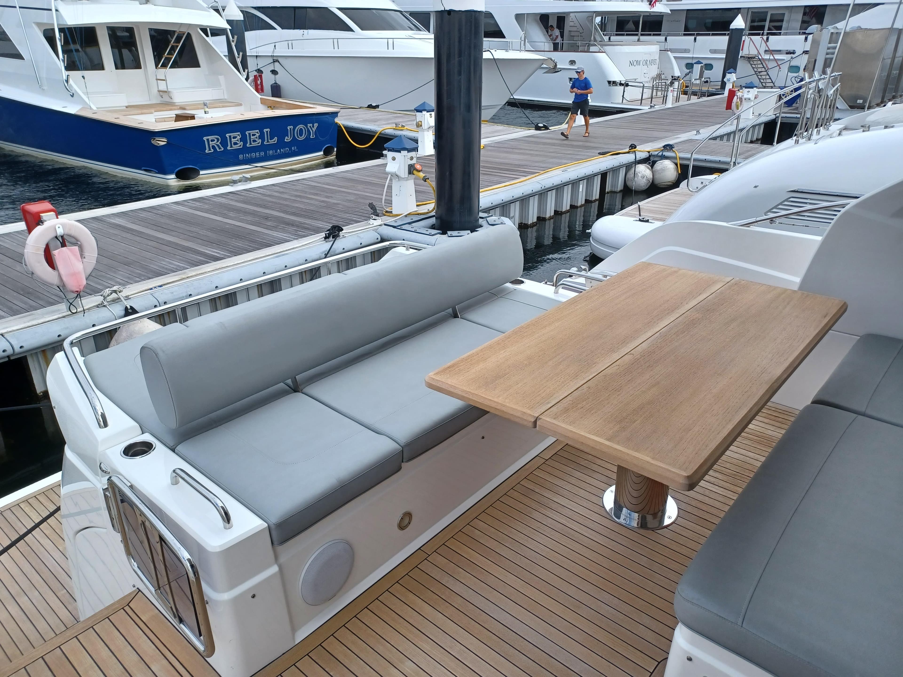 Sunseeker Predator 50 yacht, 2020 model, featuring a sleek deck with seating and a wooden table.