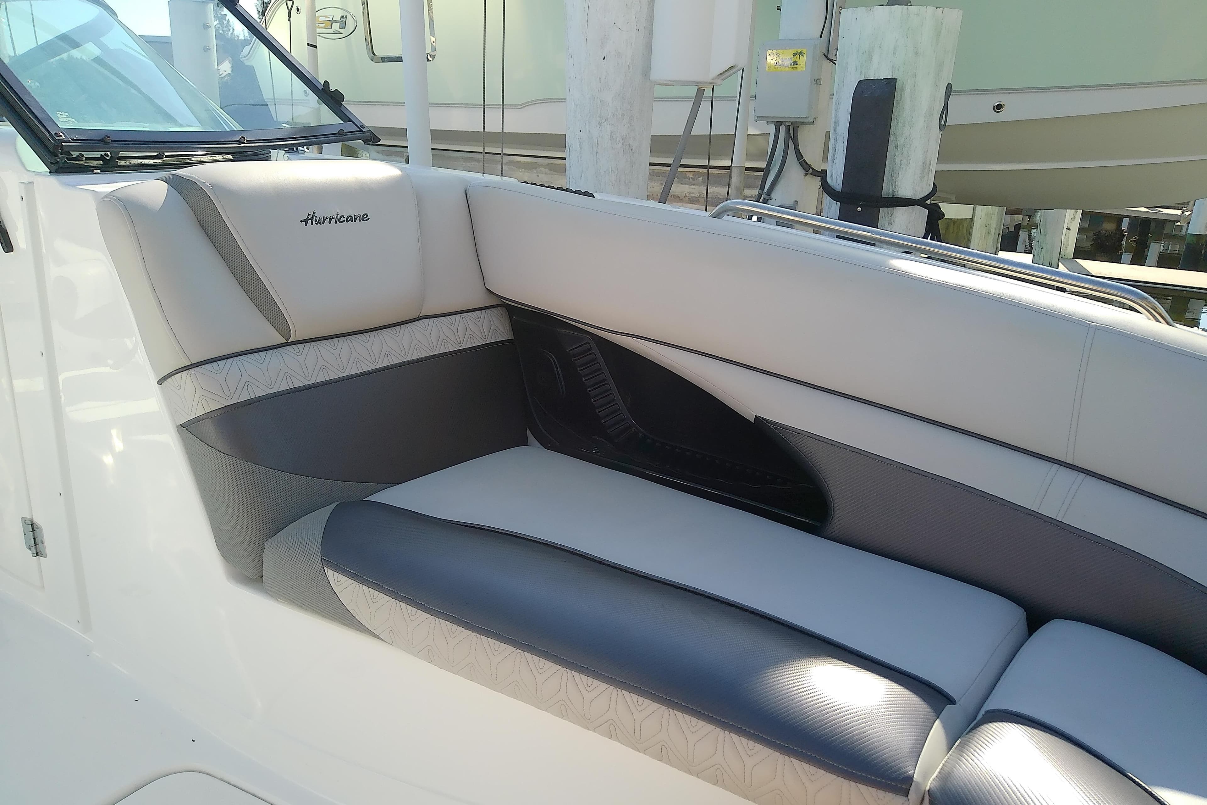 2021 Hurricane SunDeck 2410 OB boat interior with cushioned seating.