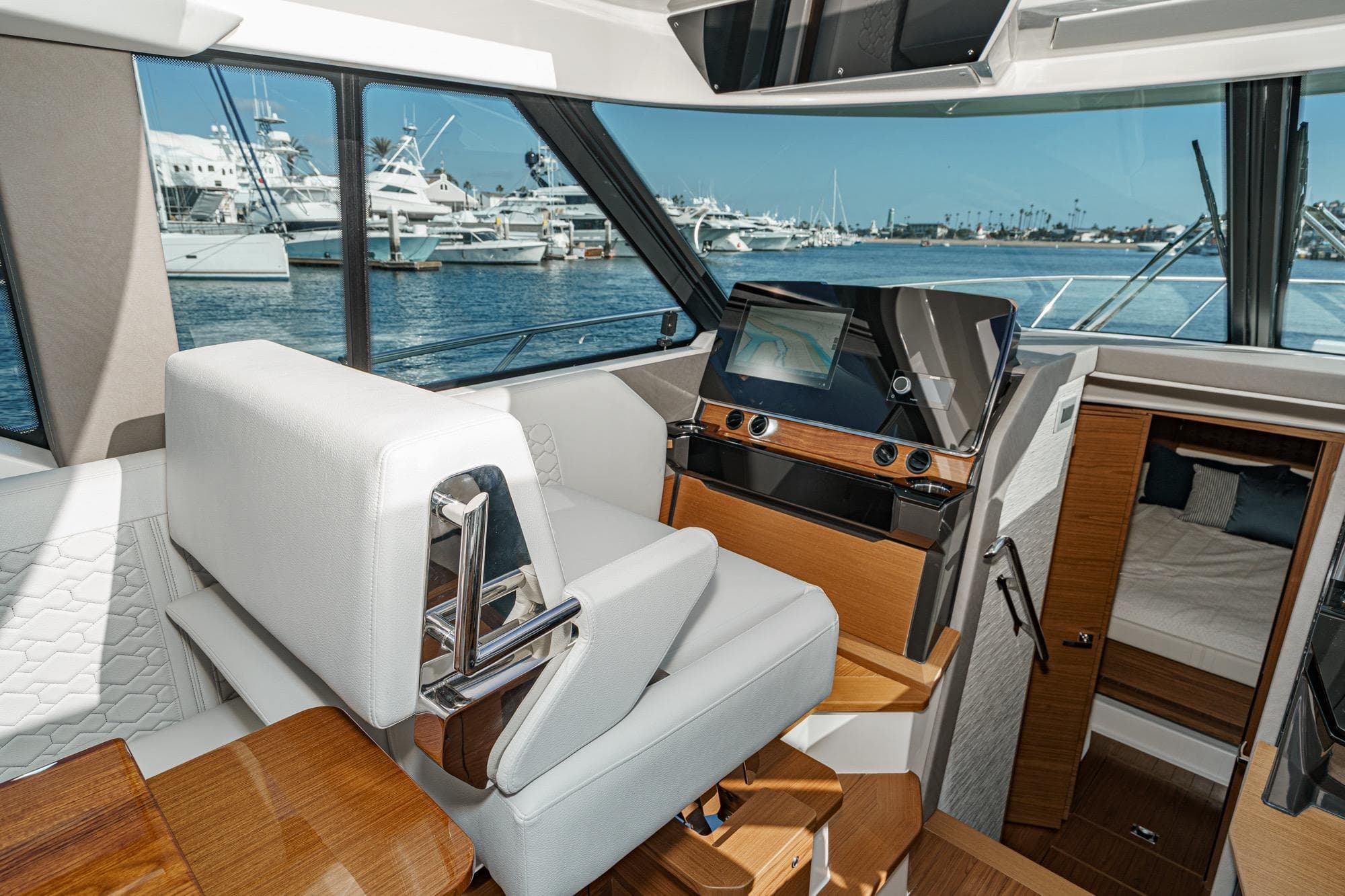 Interior of 2026 Tiara Yachts 43LE, featuring helm station and cabin view.