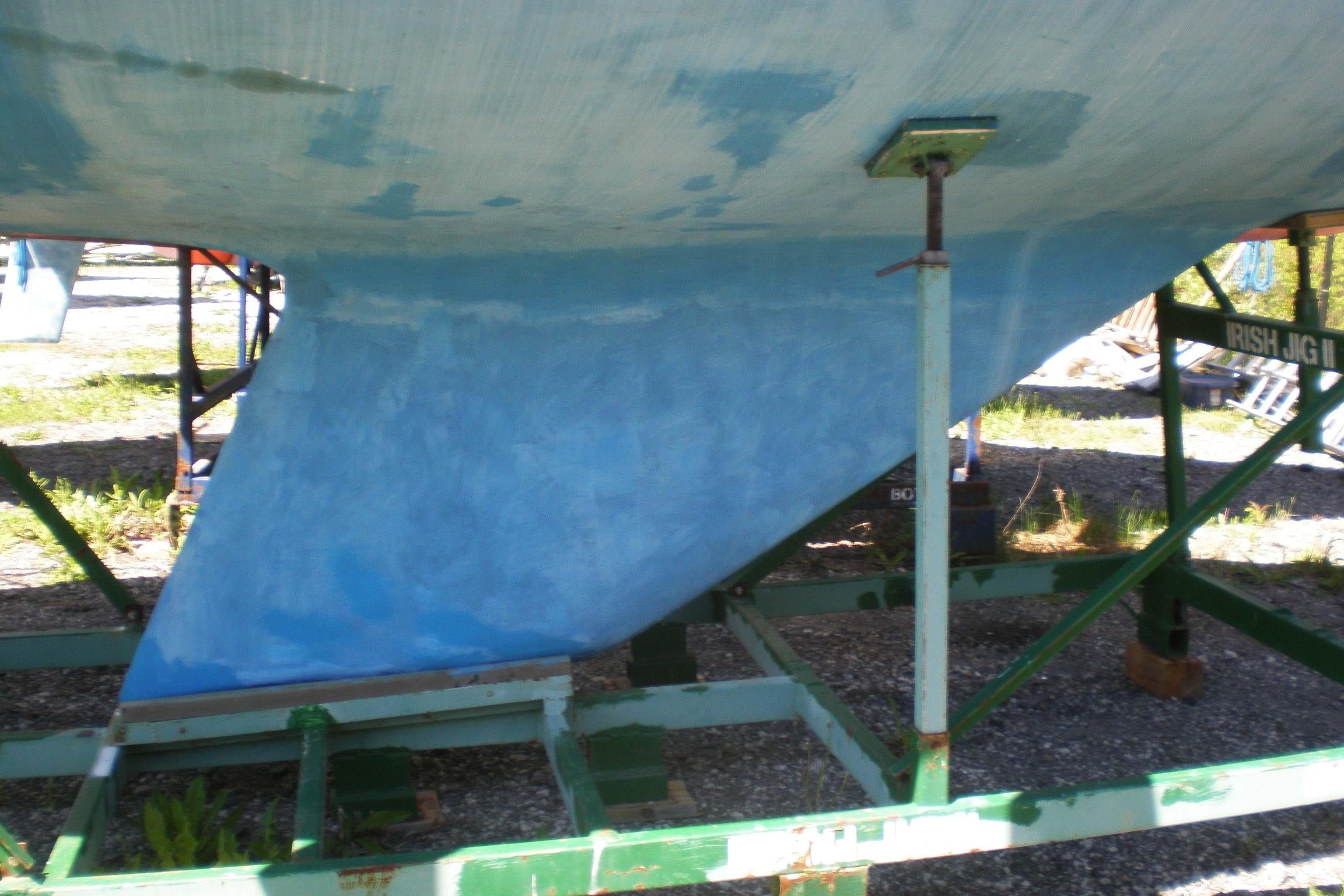1994 Catalina 30 MkIII sailboat keel on a support stand outdoors.