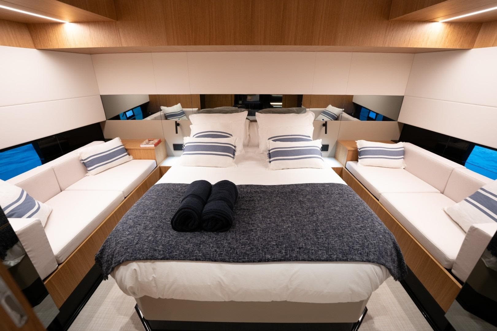 Luxurious interior of 2026 De Antonio Yachts D60, featuring elegant bedding and modern design.
