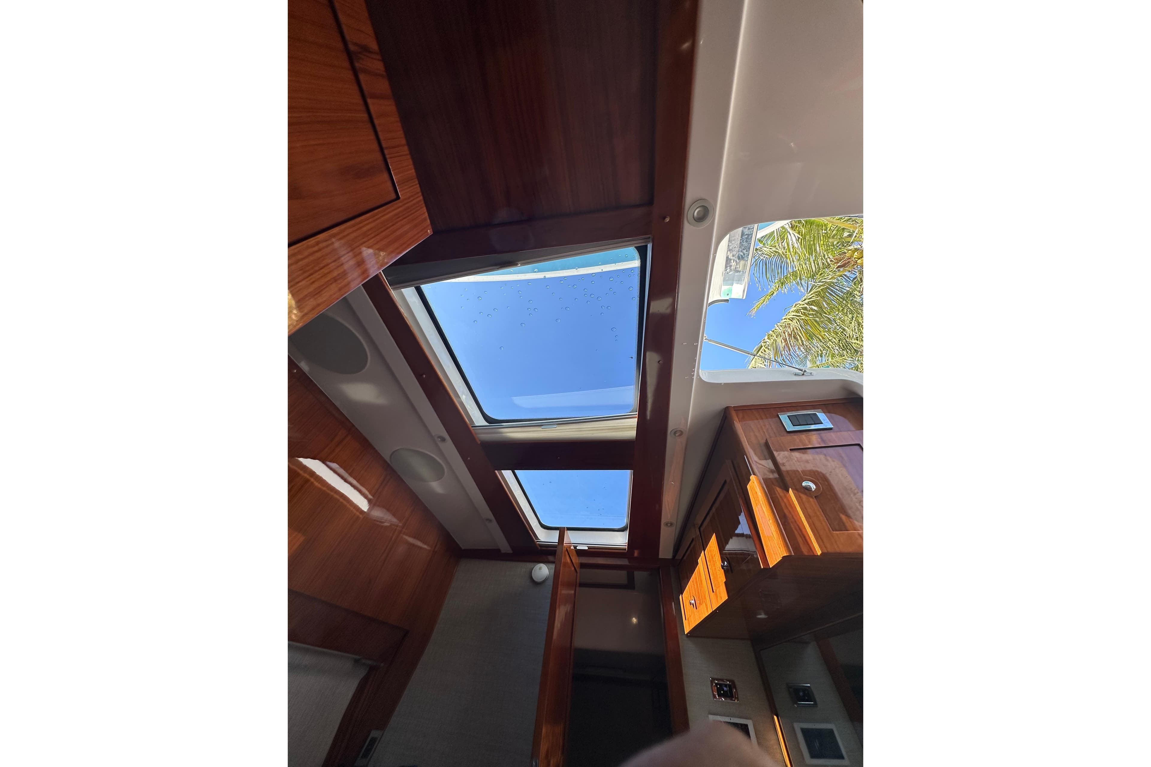 Interior view of 2021 HCB 65 Estrella yacht with skylight and wooden cabinetry.