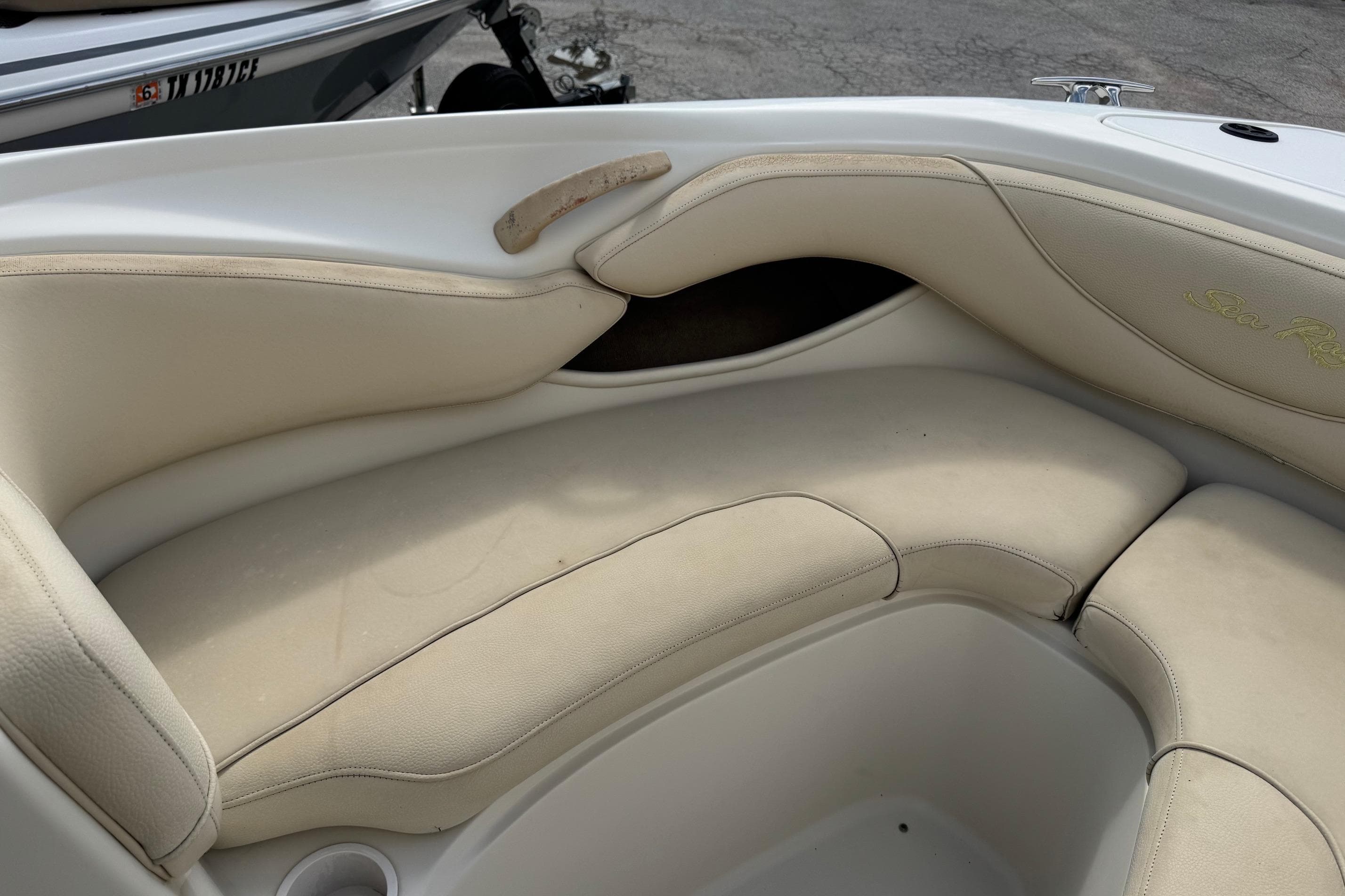 Interior seating of a 2001 Sea Ray 210 Bow Rider boat, featuring beige upholstery.