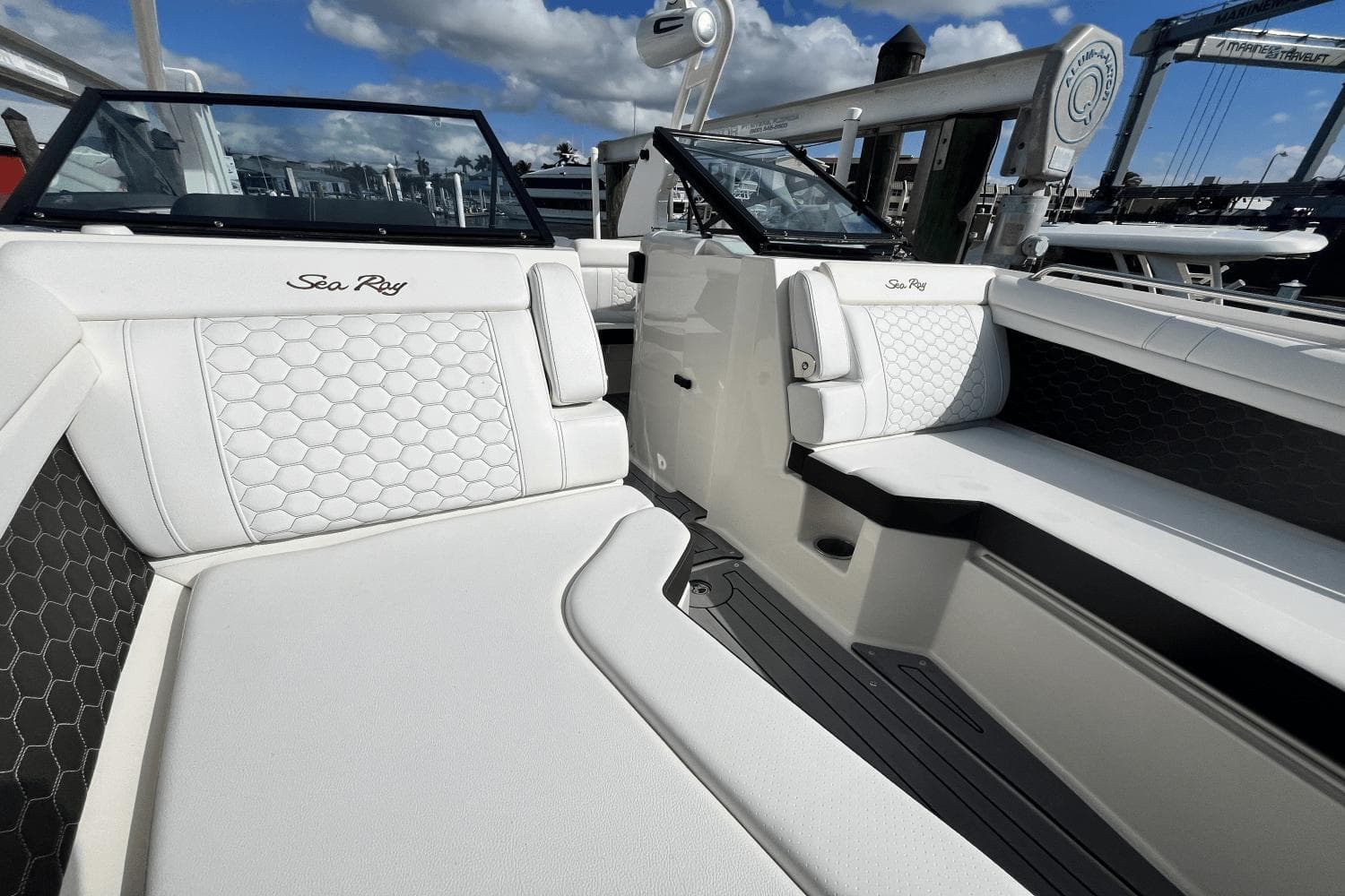 2019 Sea Ray SDX 270 Outboard boat interior with white seating and hexagonal pattern.