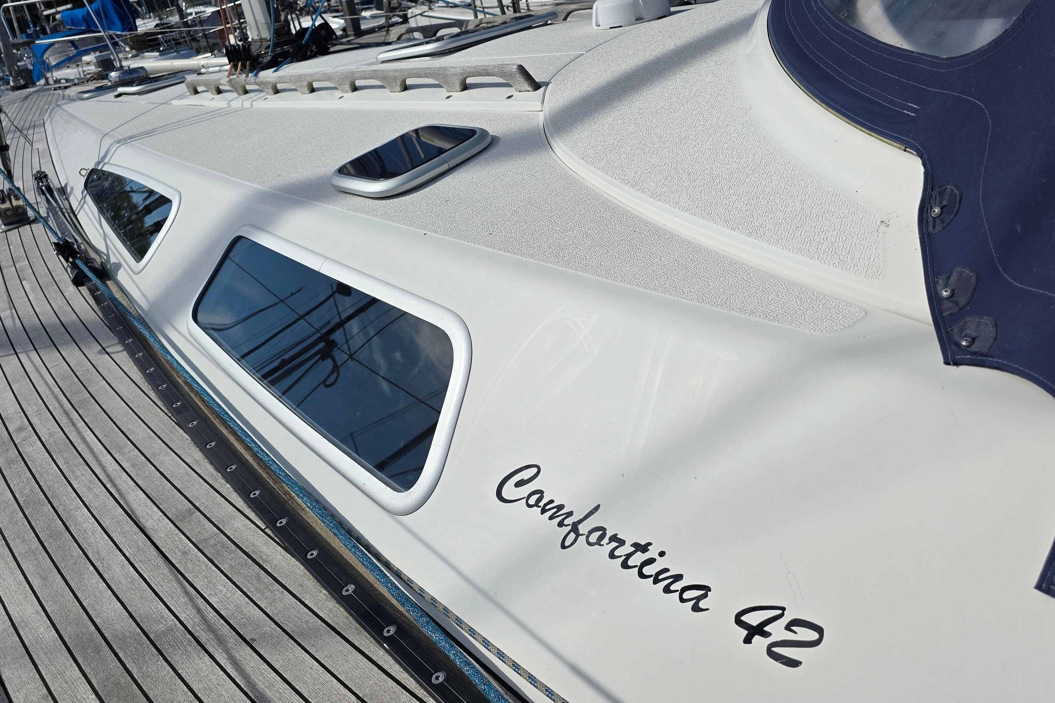 2002 Comfortina 42 sailboat deck with sleek design and windows.