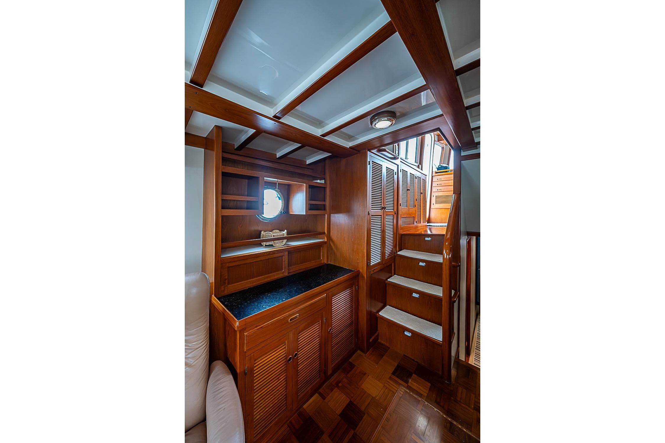 Luxurious wooden interior of 2008 Kadey-Krogen 48 North Sea yacht with stairs and storage.