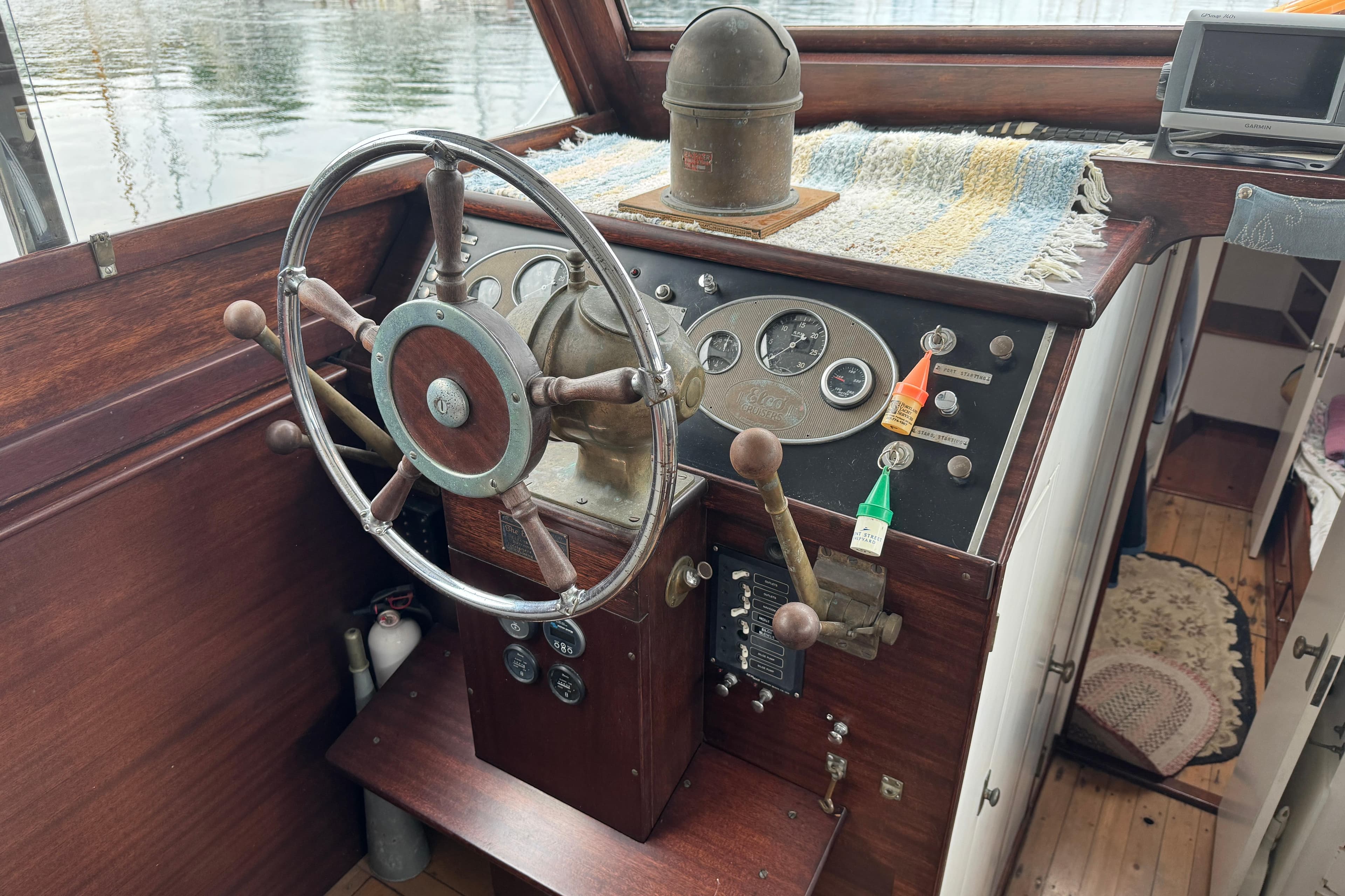 1940 Elco Cruisette helm with vintage steering wheel and control panel.
