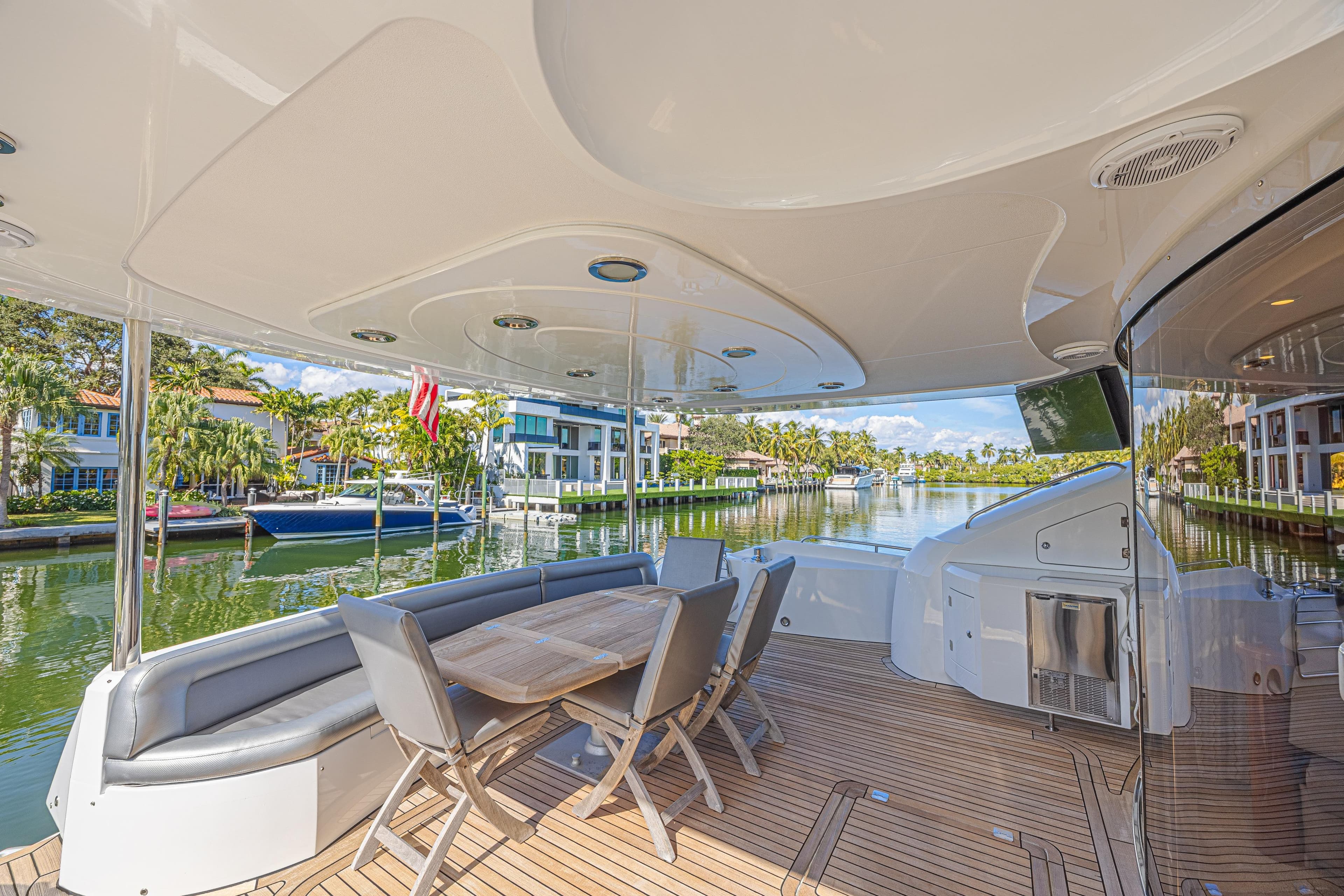 Luxurious 2006 Sunseeker 75 Yacht deck with elegant seating and scenic waterfront view.