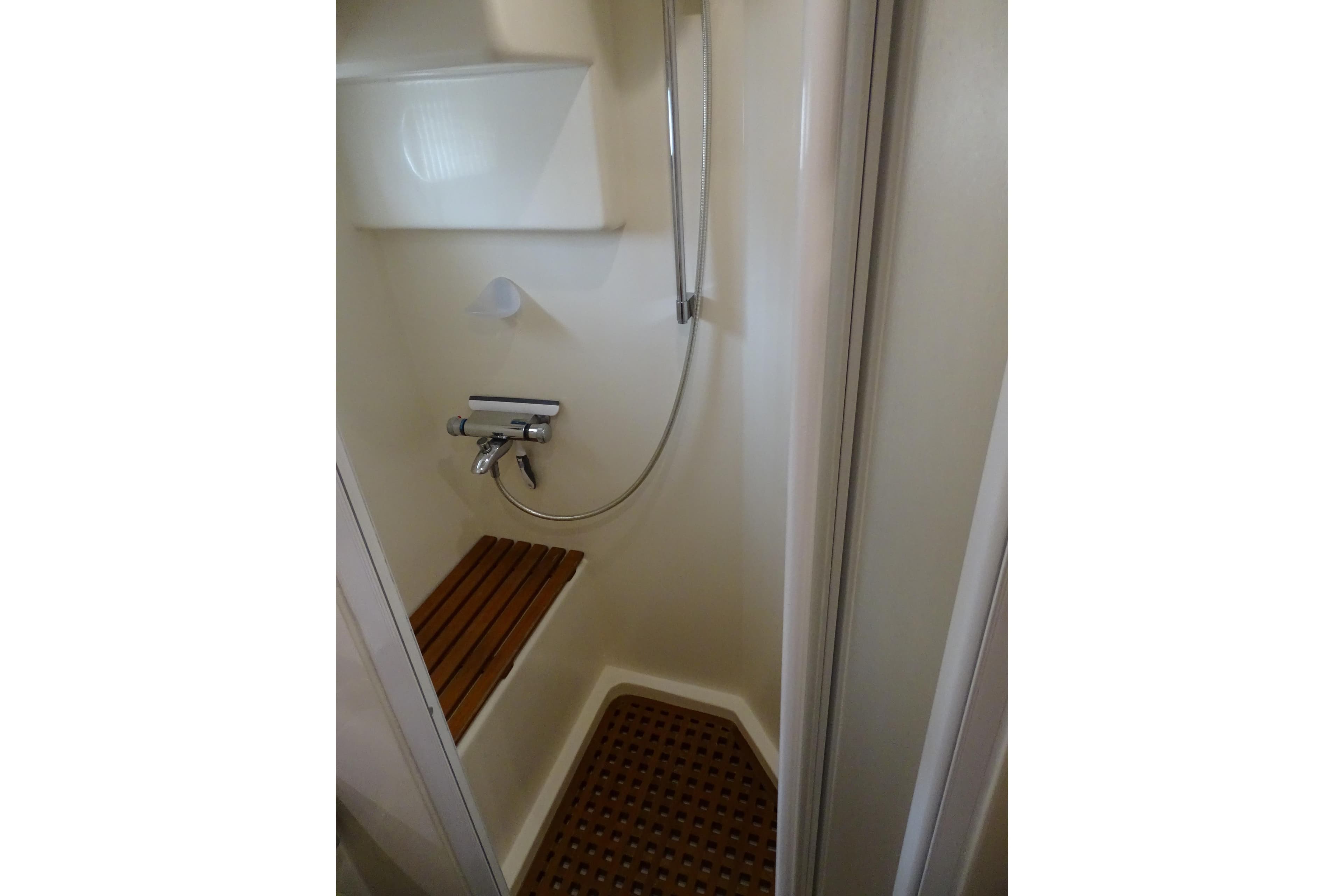 Compact shower area with wooden seat in 2004 Selene 53 yacht.