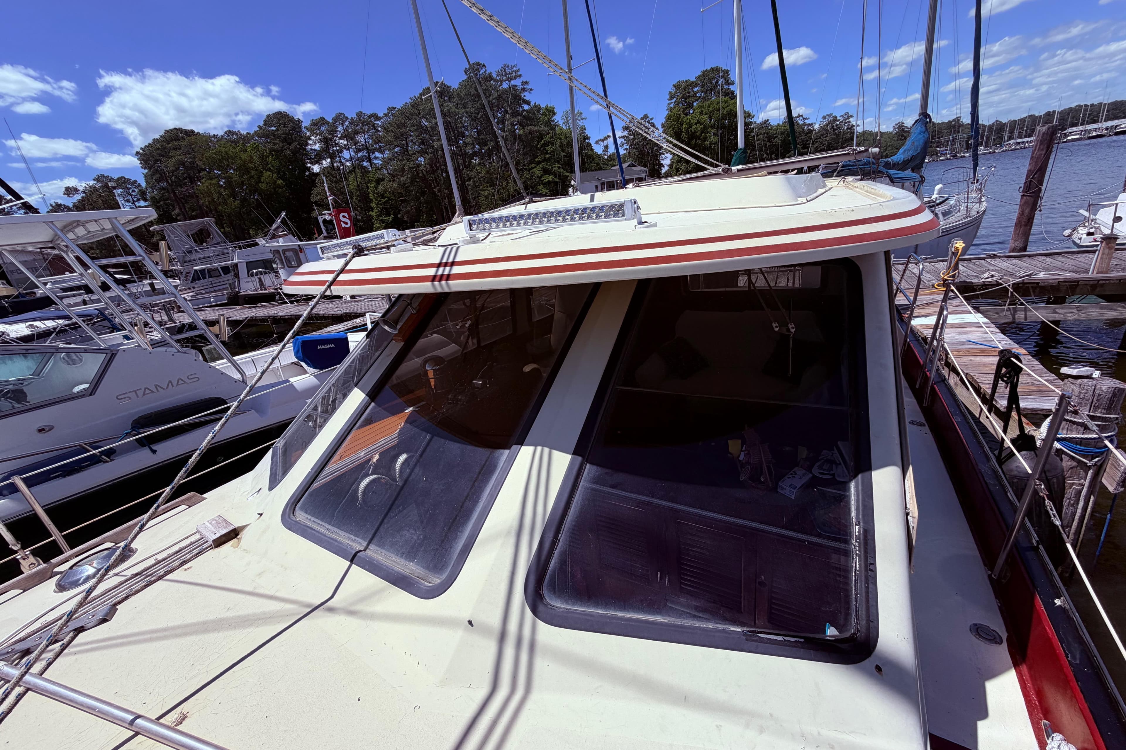 1985 Lancer Yachts 40 Motorsailer docked at a marina under a clear blue sky.