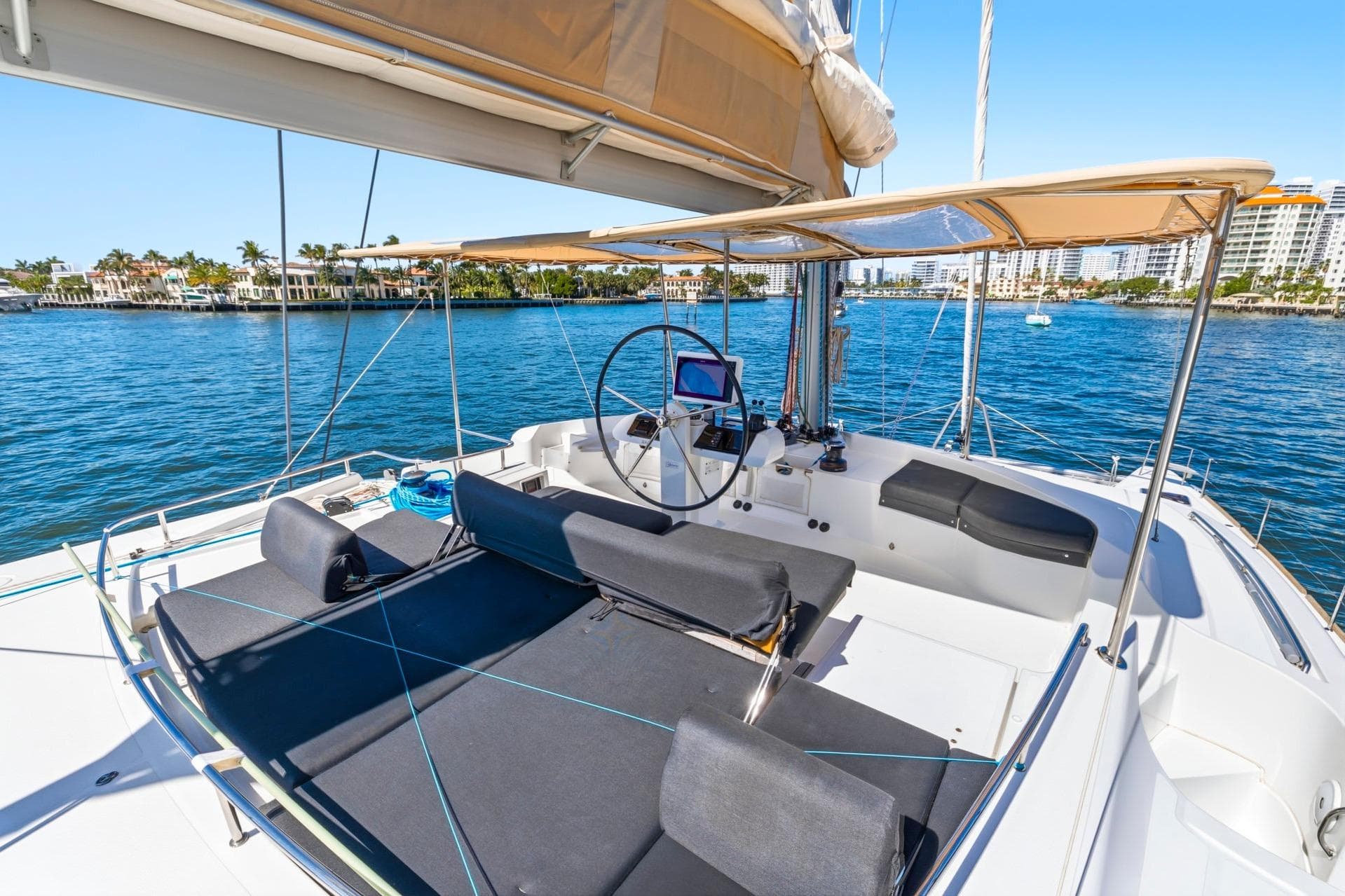 Luxurious 2021 Lagoon 52 F catamaran with spacious deck and scenic waterfront view.