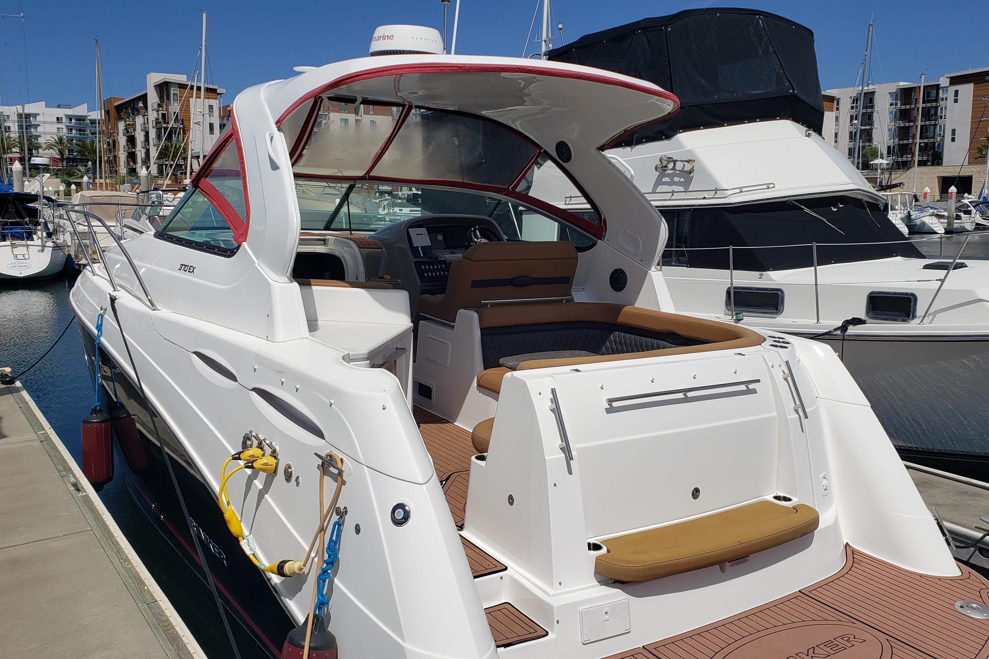 2019 Rinker EX 370 yacht docked at marina, showcasing sleek design and spacious deck.