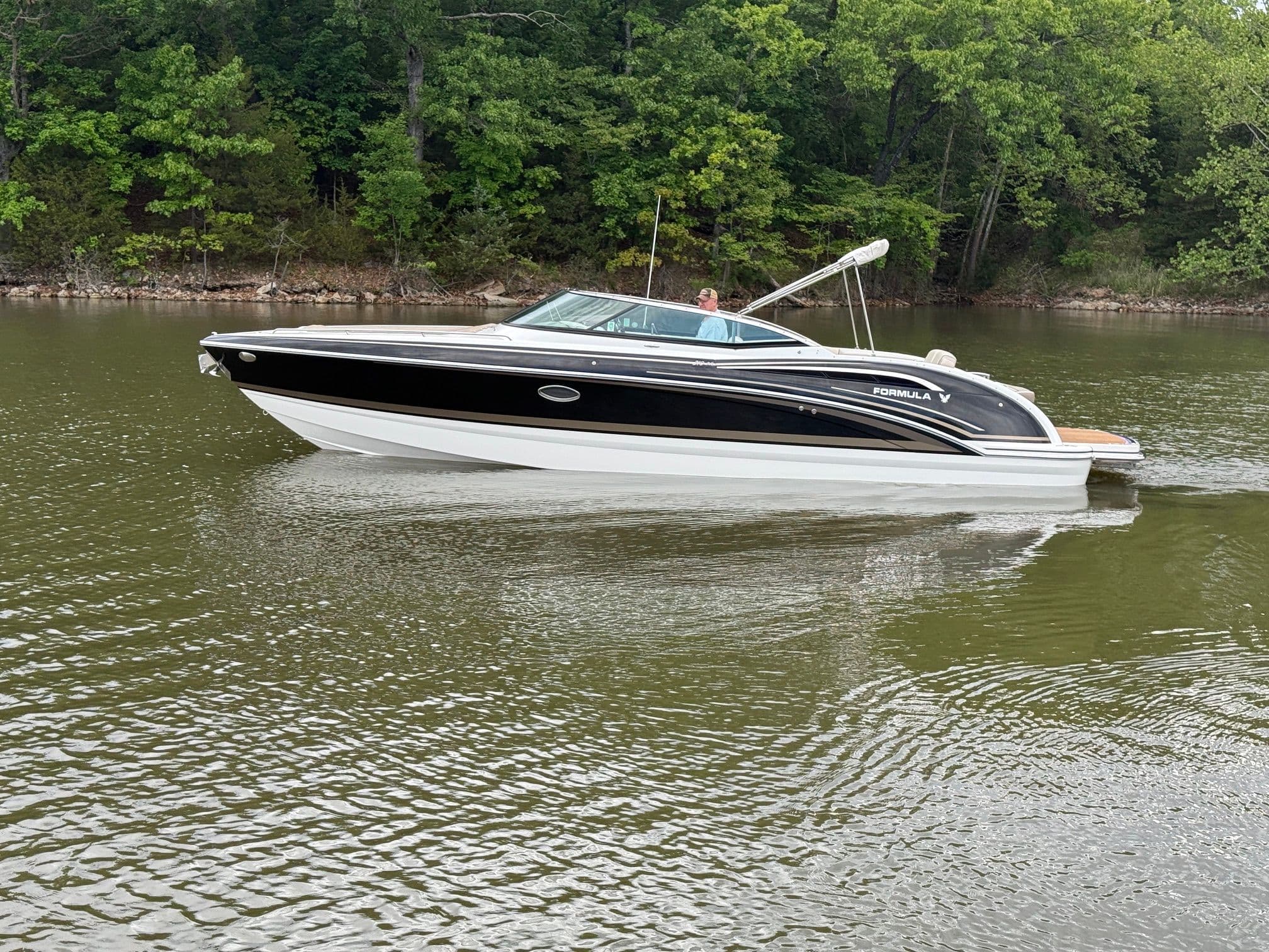 2016 Formula 310 BR boat on a calm lake.