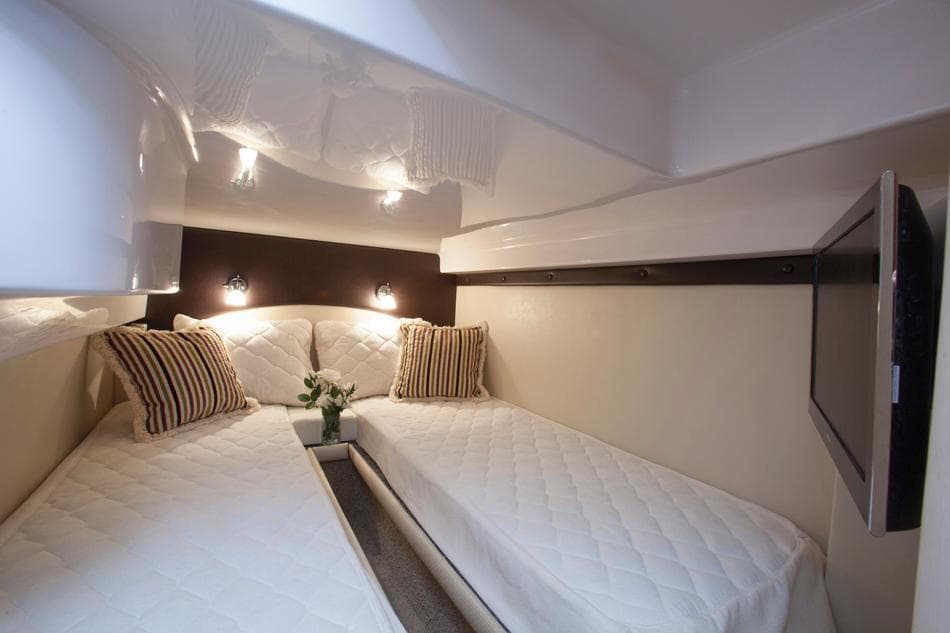 Manufacturer Provided Image: 2015 Regal 42 Sport Coupe cabin with twin beds, modern lighting, and striped pillows.